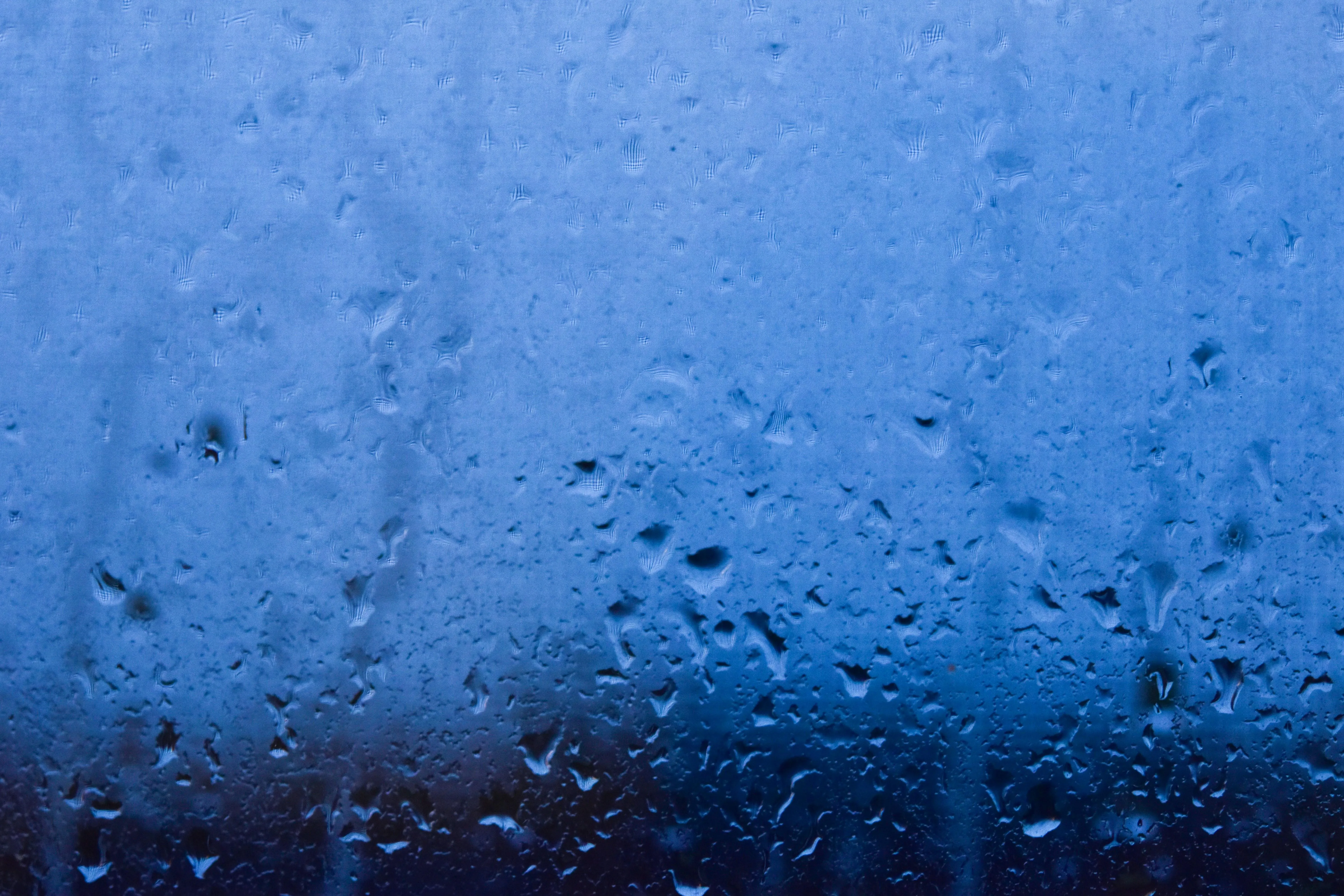 Blue Tinted Window with Clear Water Droplets on Glass