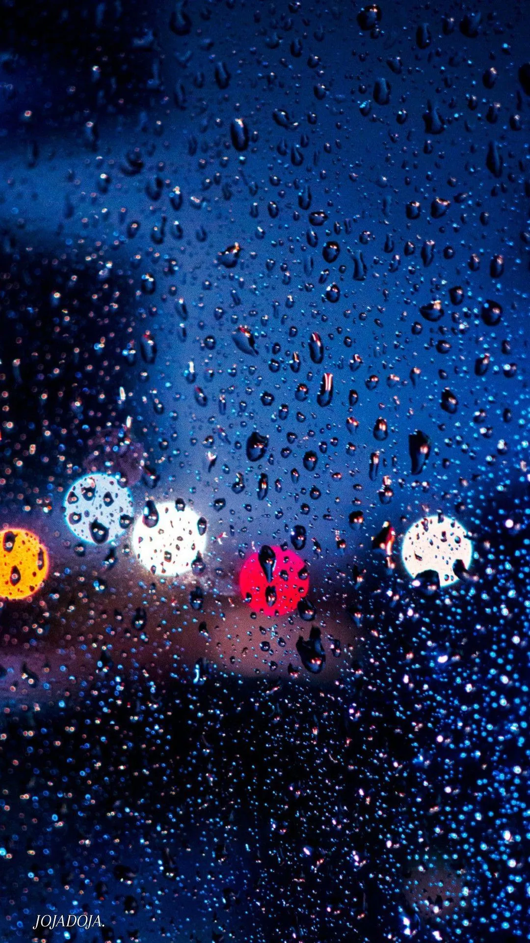 Blurred Red and Blue Lights in Rain Covered City View