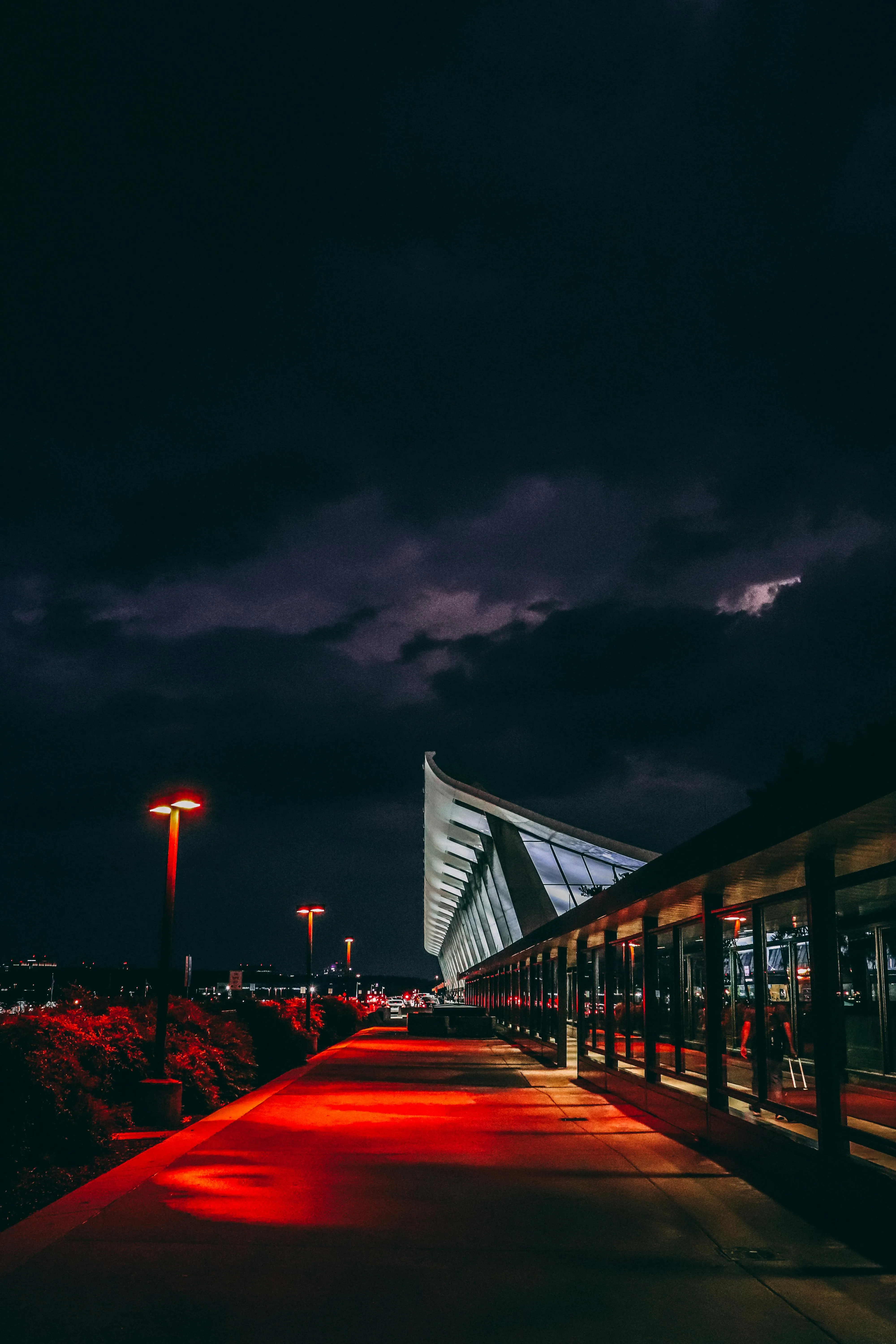 Bridge Illuminated Under Dark Moody Clouds at Night