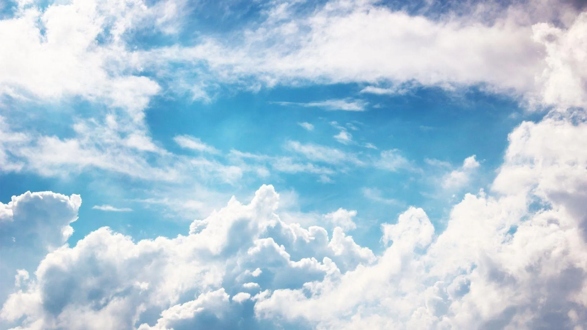 Bright Blue Sky Filled with Large Fluffy White Clouds