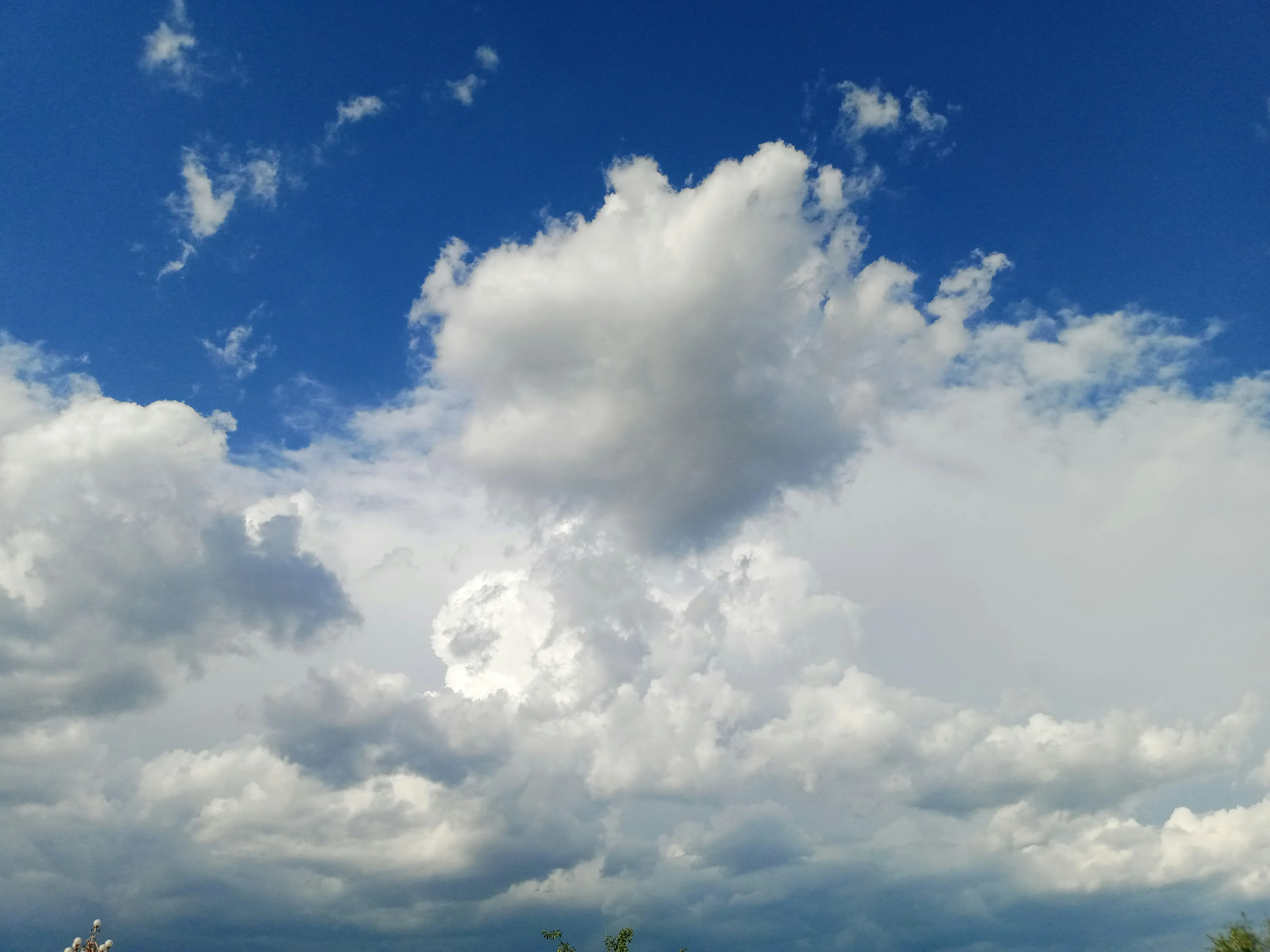 Bright Blue Sky Filled with Large Fluffy White Clouds Image