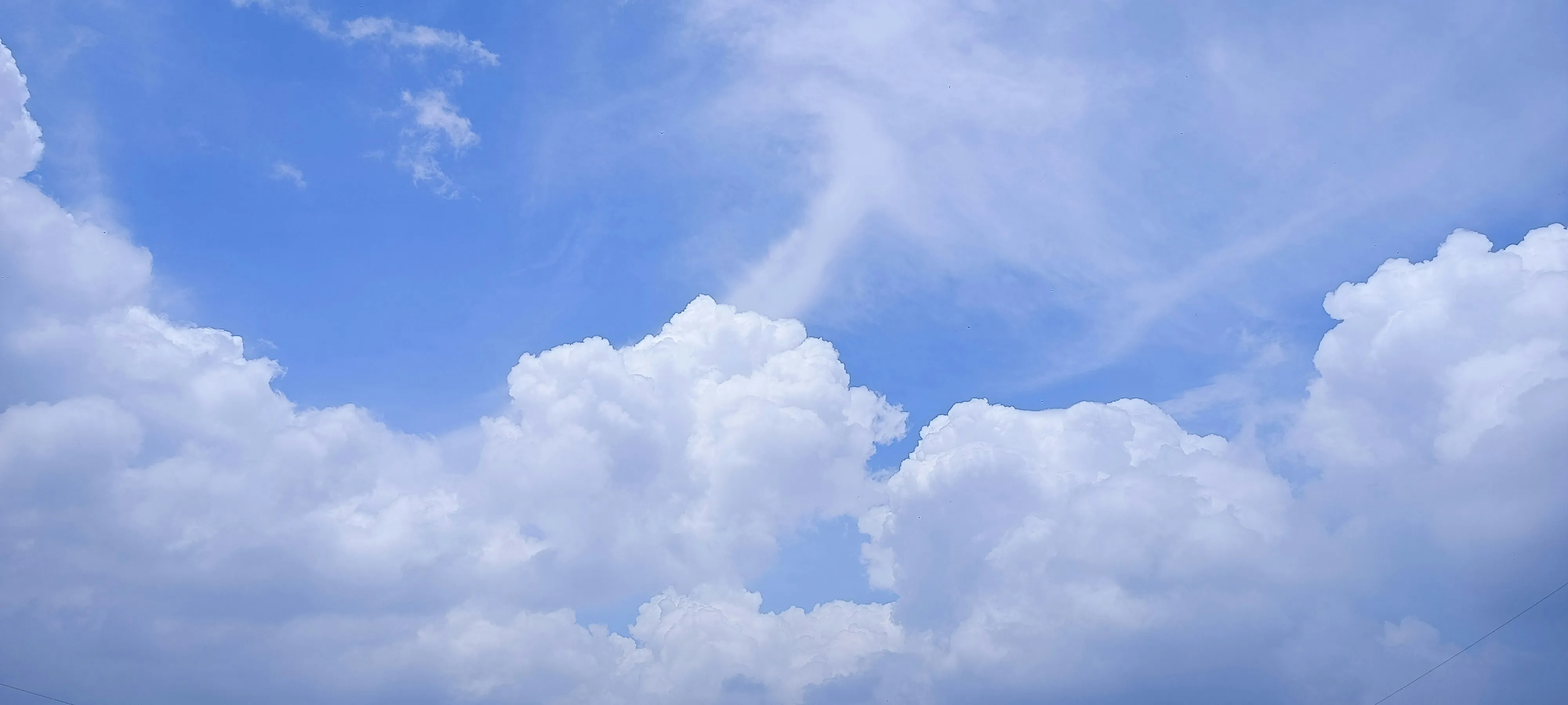 Bright Blue Sky Filled with Puffy White Clouds Wallpaper 4K