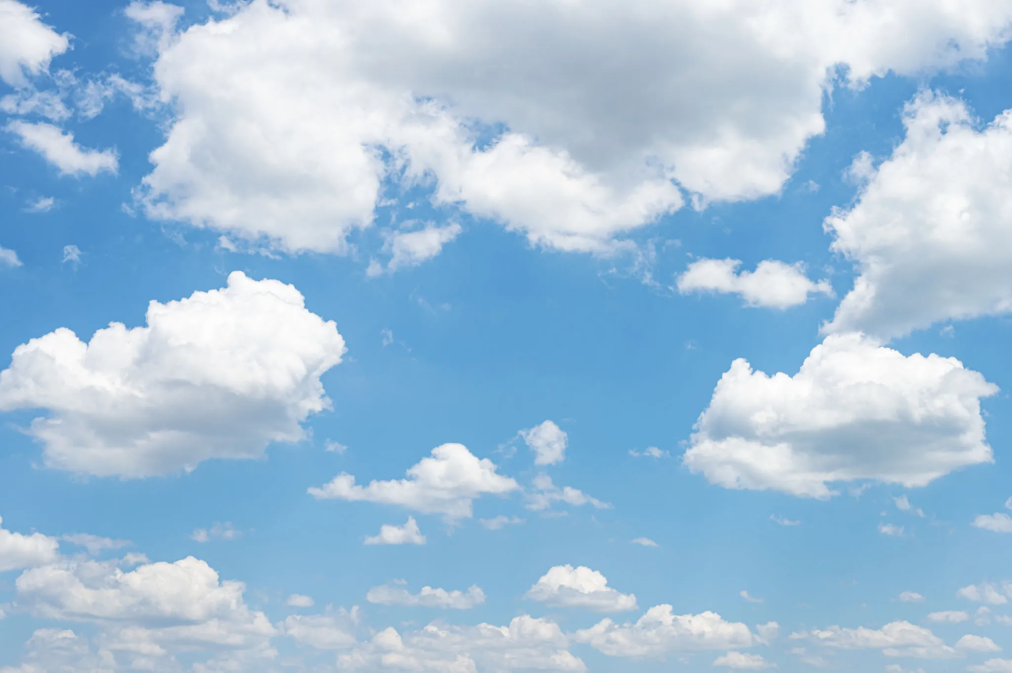 Bright Blue Sky Filled with Soft White Fluffy Clouds Image