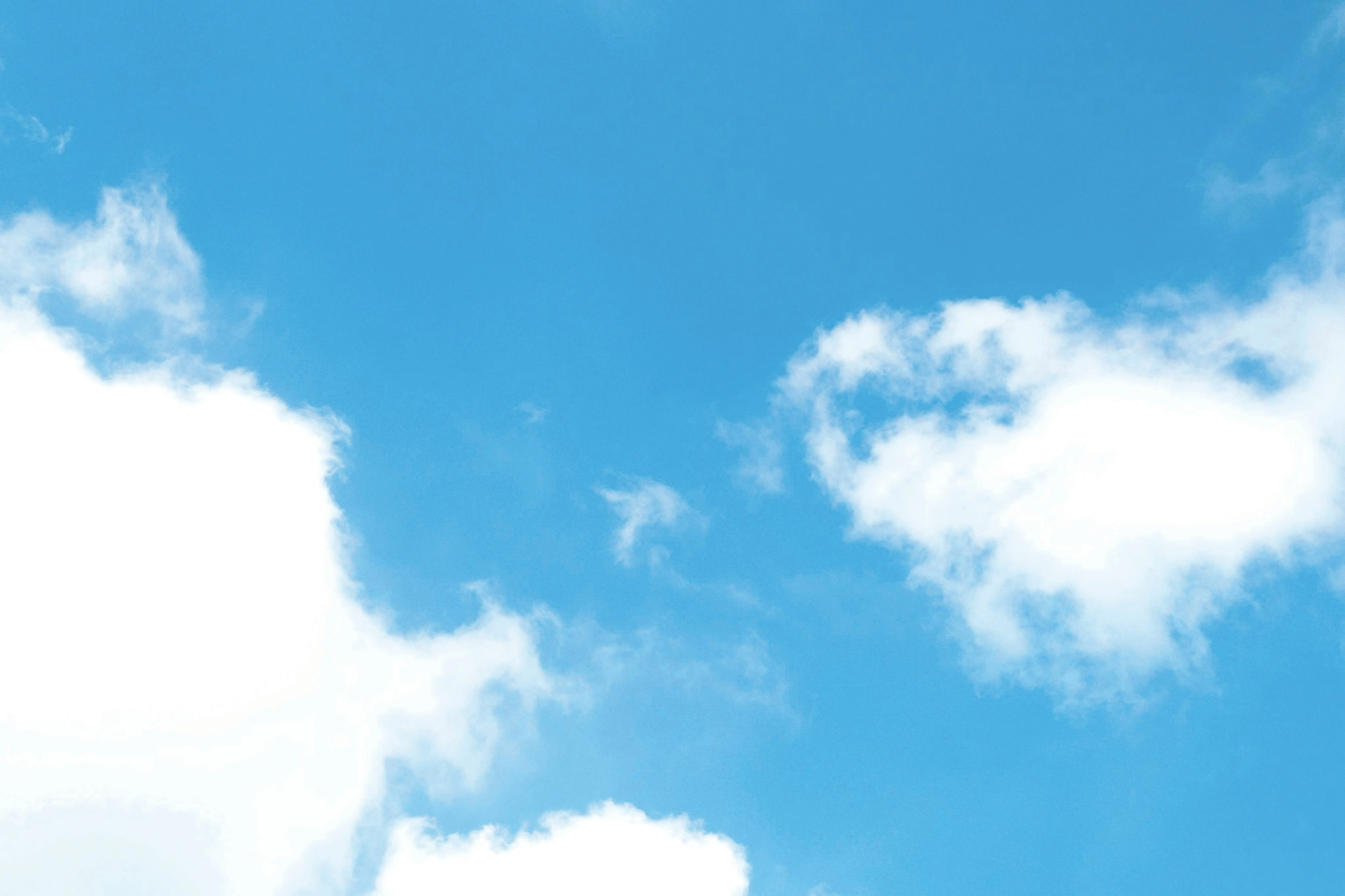 Bright Blue Sky with Fluffy White Clouds on a Sunny Day