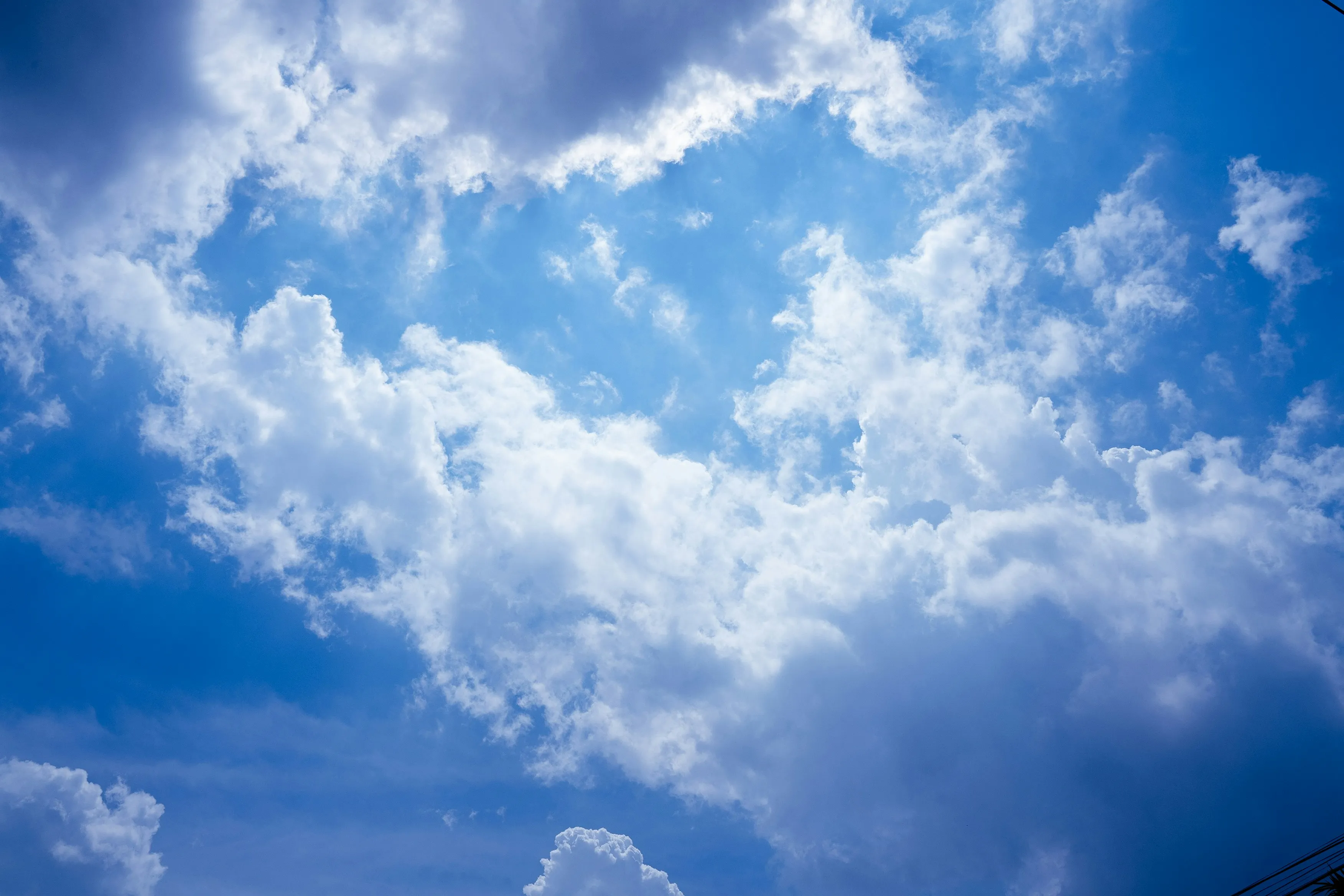 Bright Blue Sky with Large White Puffy Clouds Above