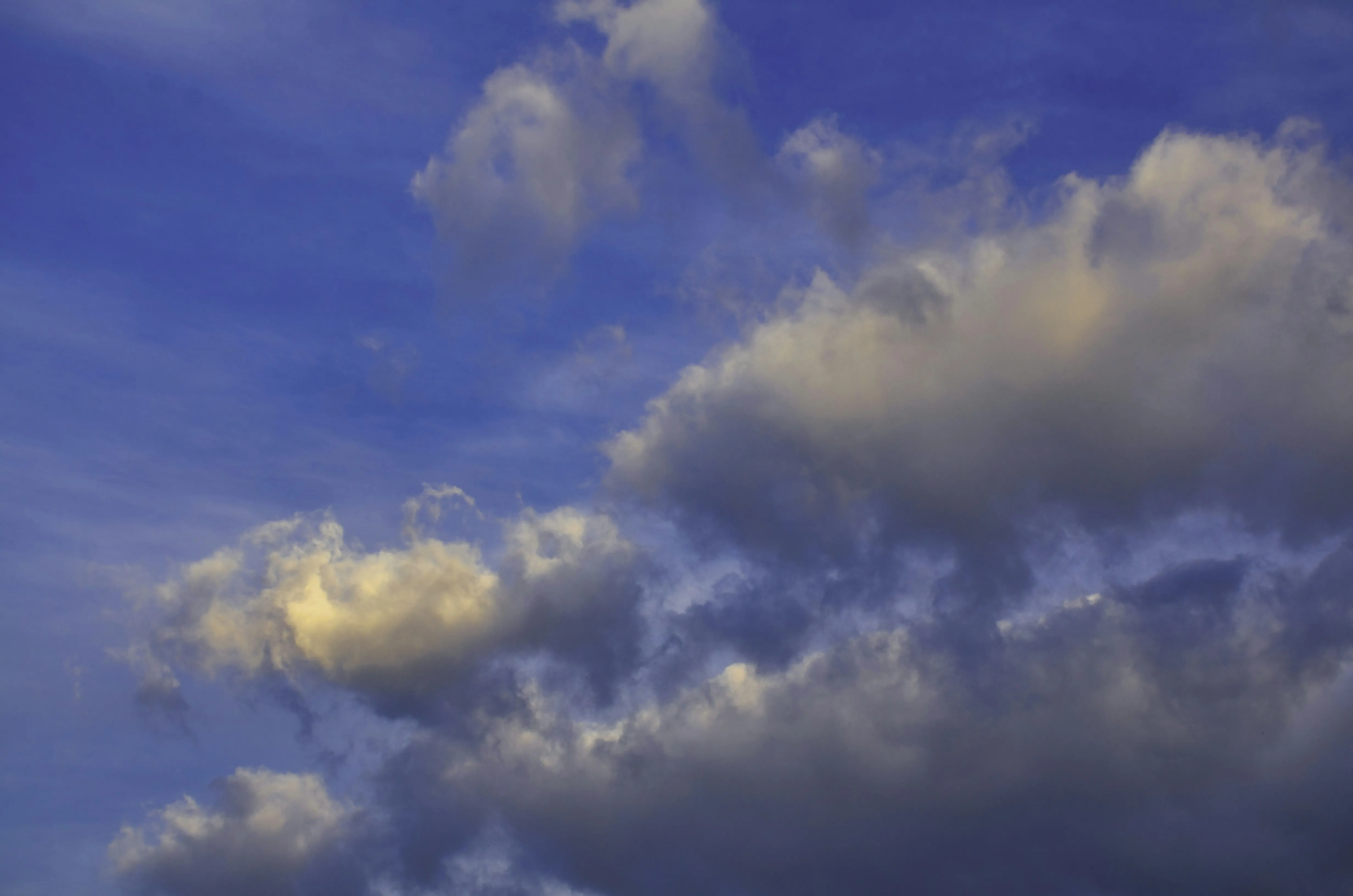 Bright Blue Sky with Light Puffy Clouds Scattered Wallpaper