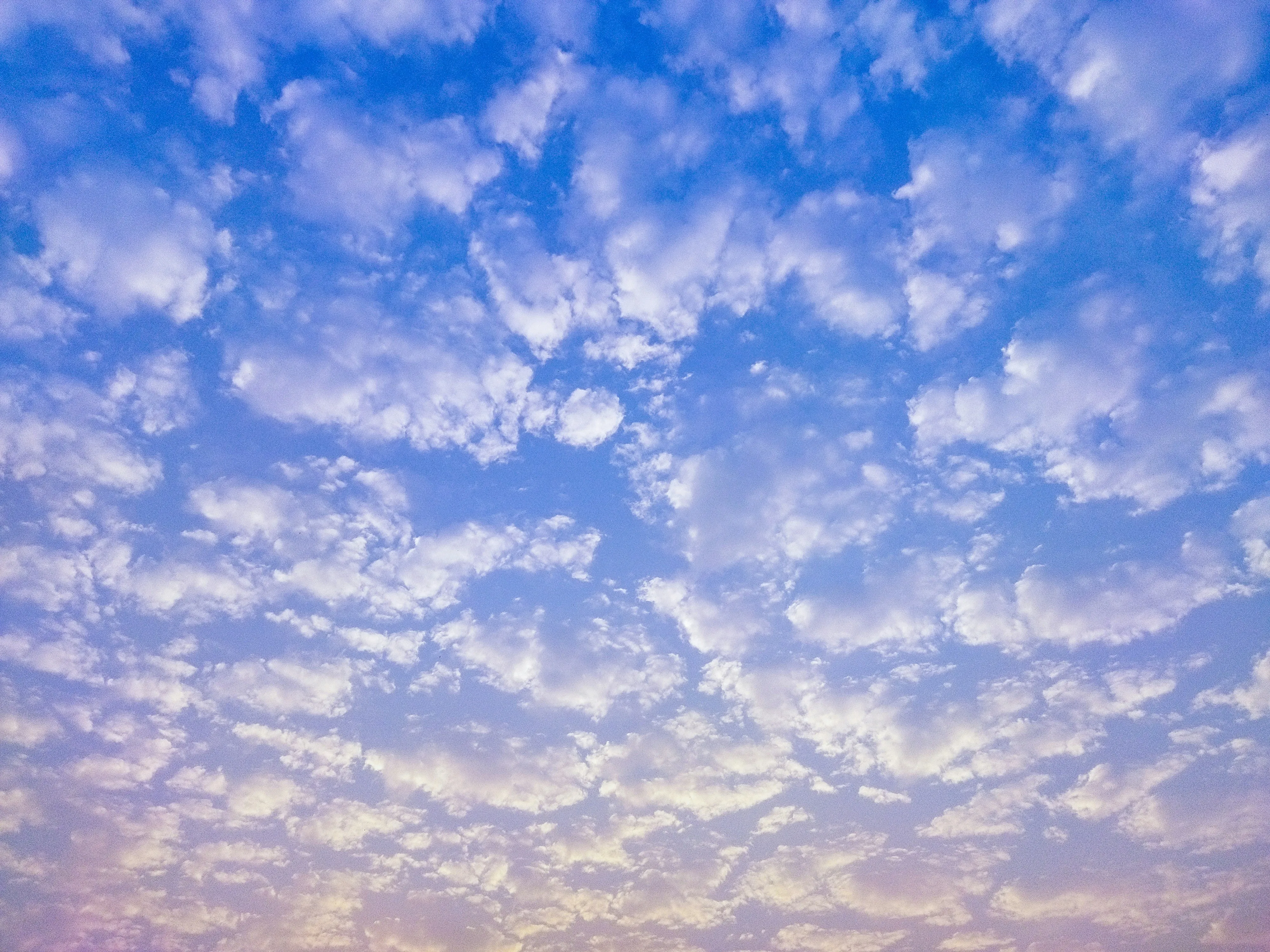 Bright Blue Sky with White Clouds Creating a Serene Atmosphere