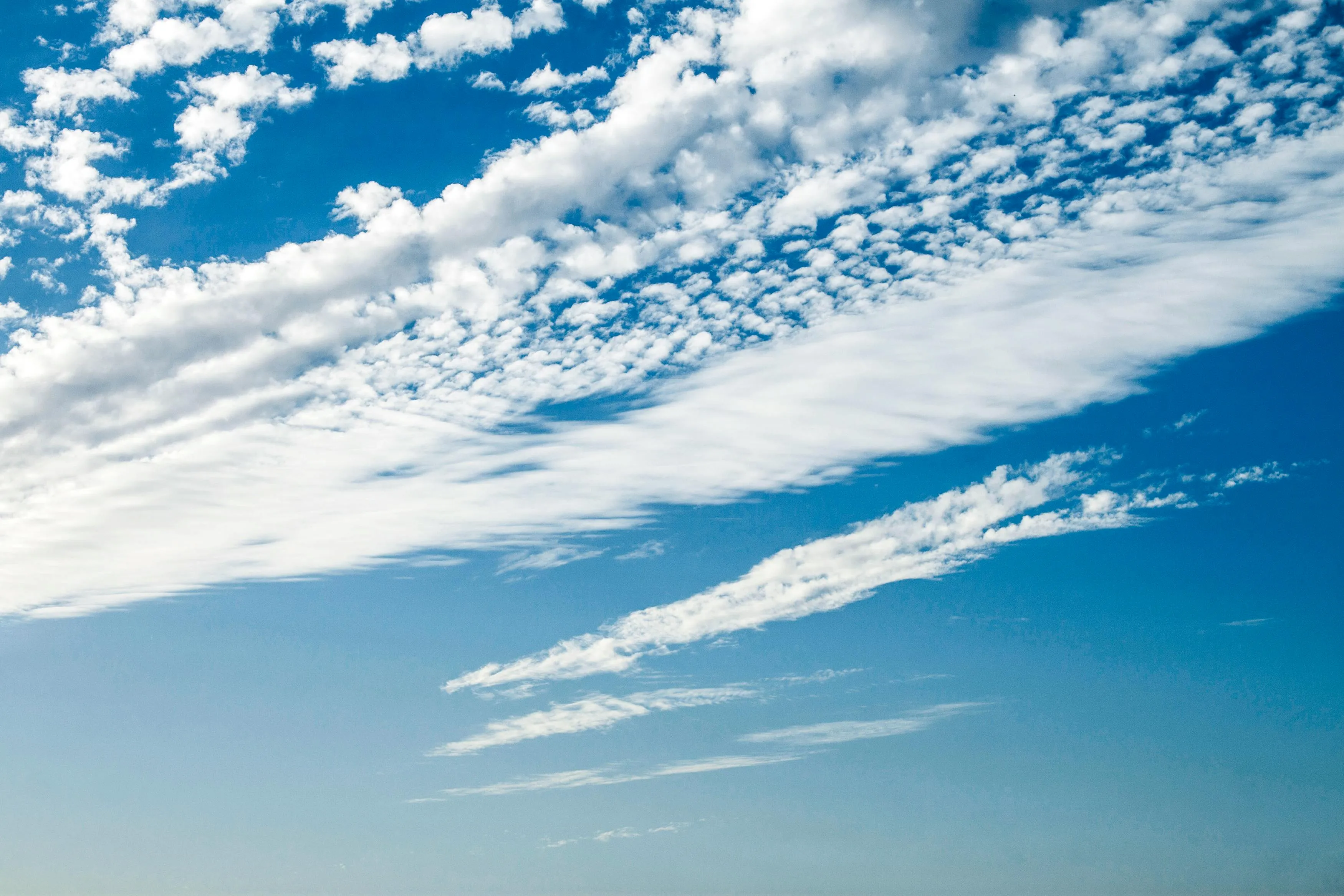 Bright Blue Sky with White Streaks of Clouds on a Clear Day