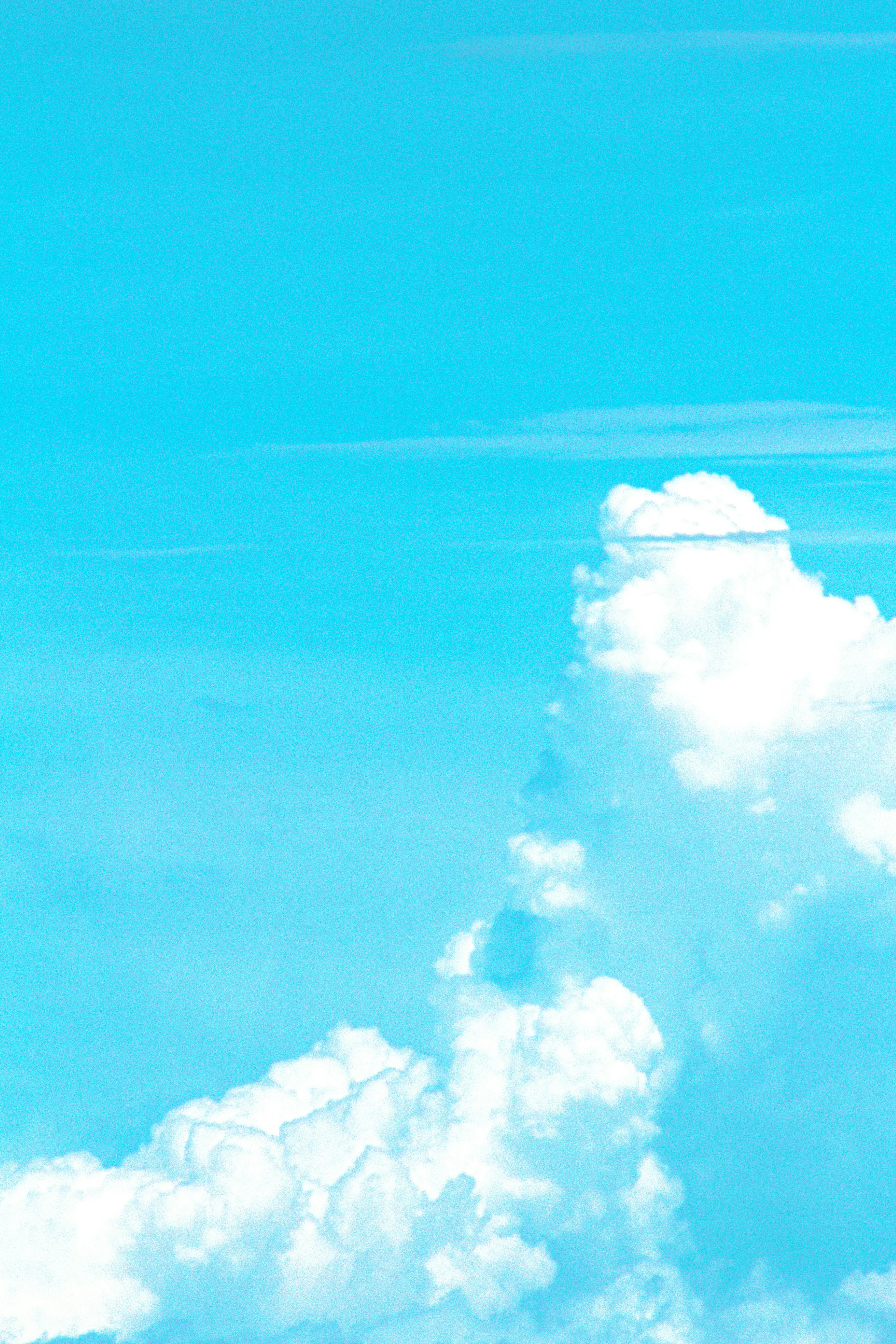 Bright Cyan Sky with Cumulus Cloud Rising Upward Wallpaper
