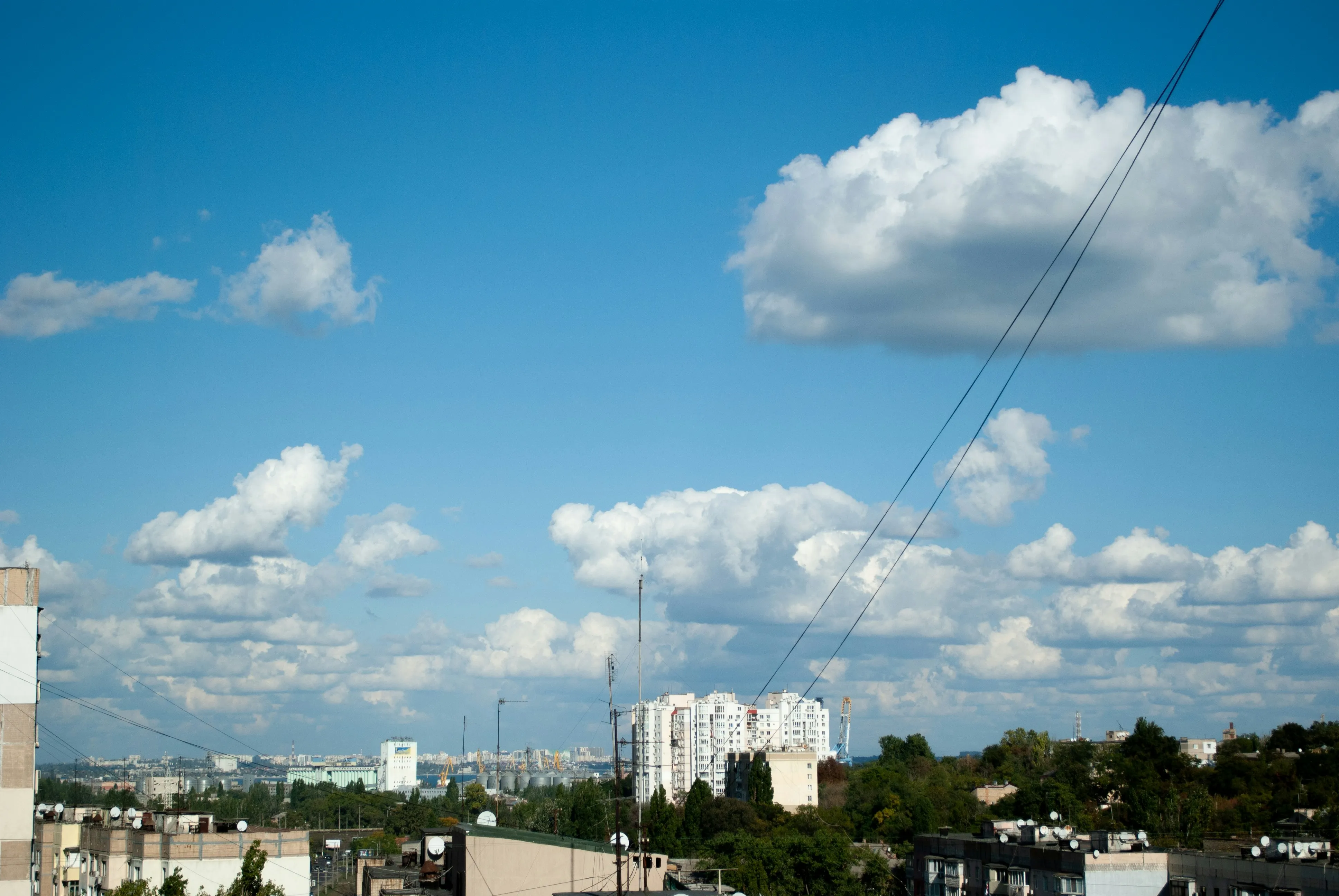 Bright Day with Cumulus Clouds Over Urban Cityscape