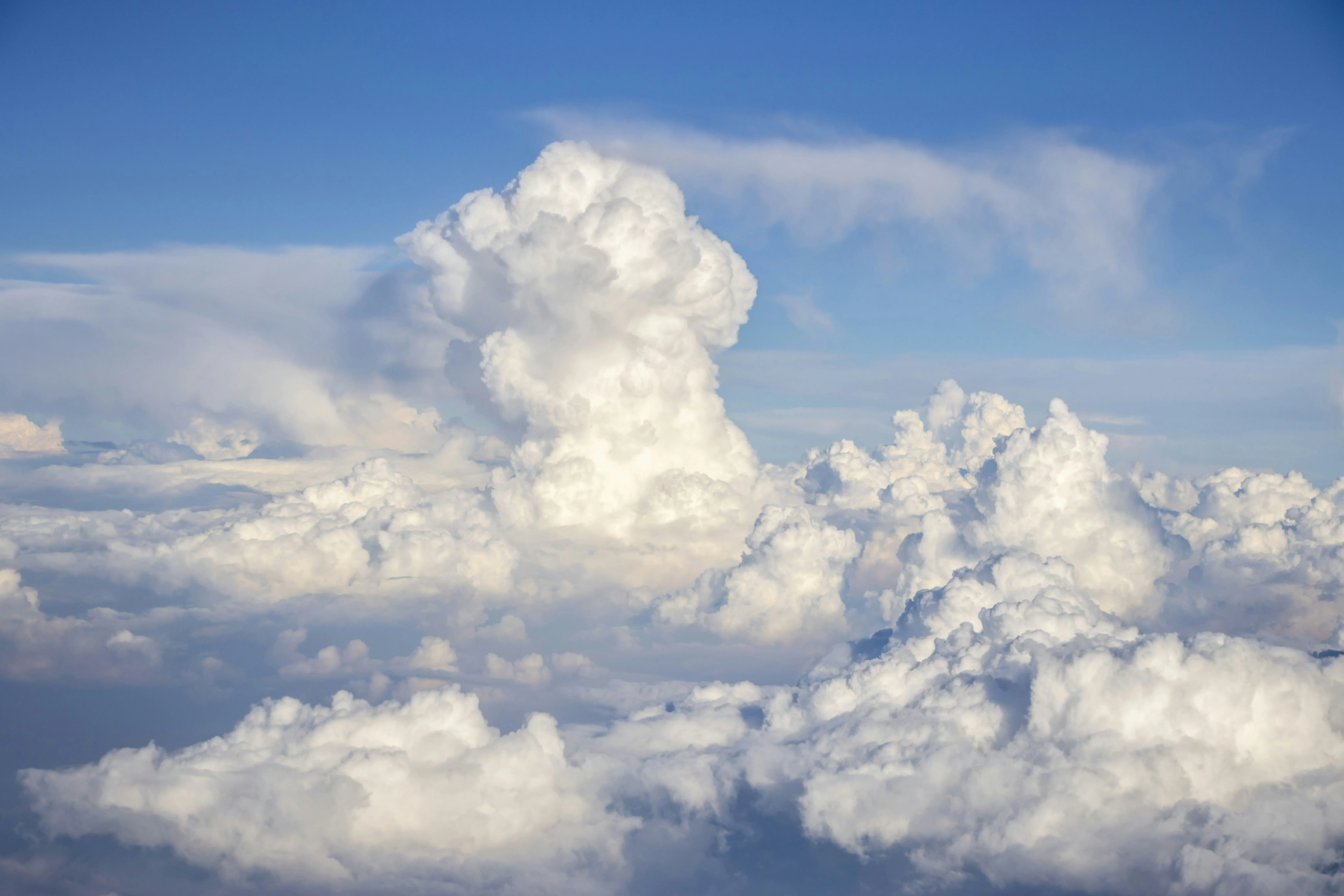 Bright Daytime Sky Filled with White Puffy Clouds Wallpaper
