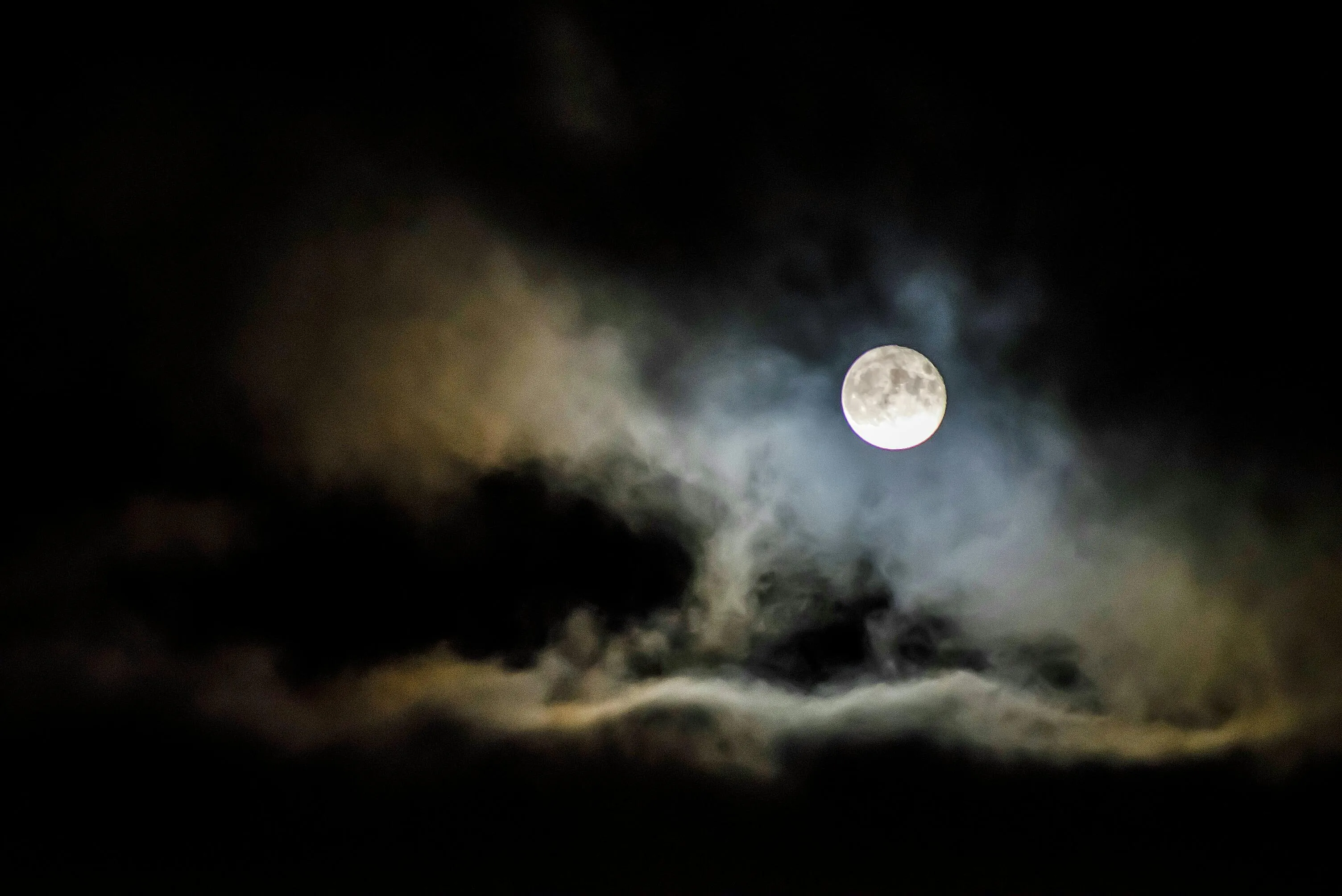 Bright Full Moon Shining Through Dark Thick Night Clouds