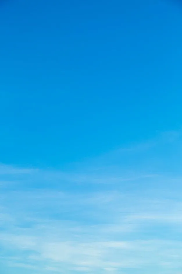 Bright Midday Sky with Gentle Streaks of White Clouds