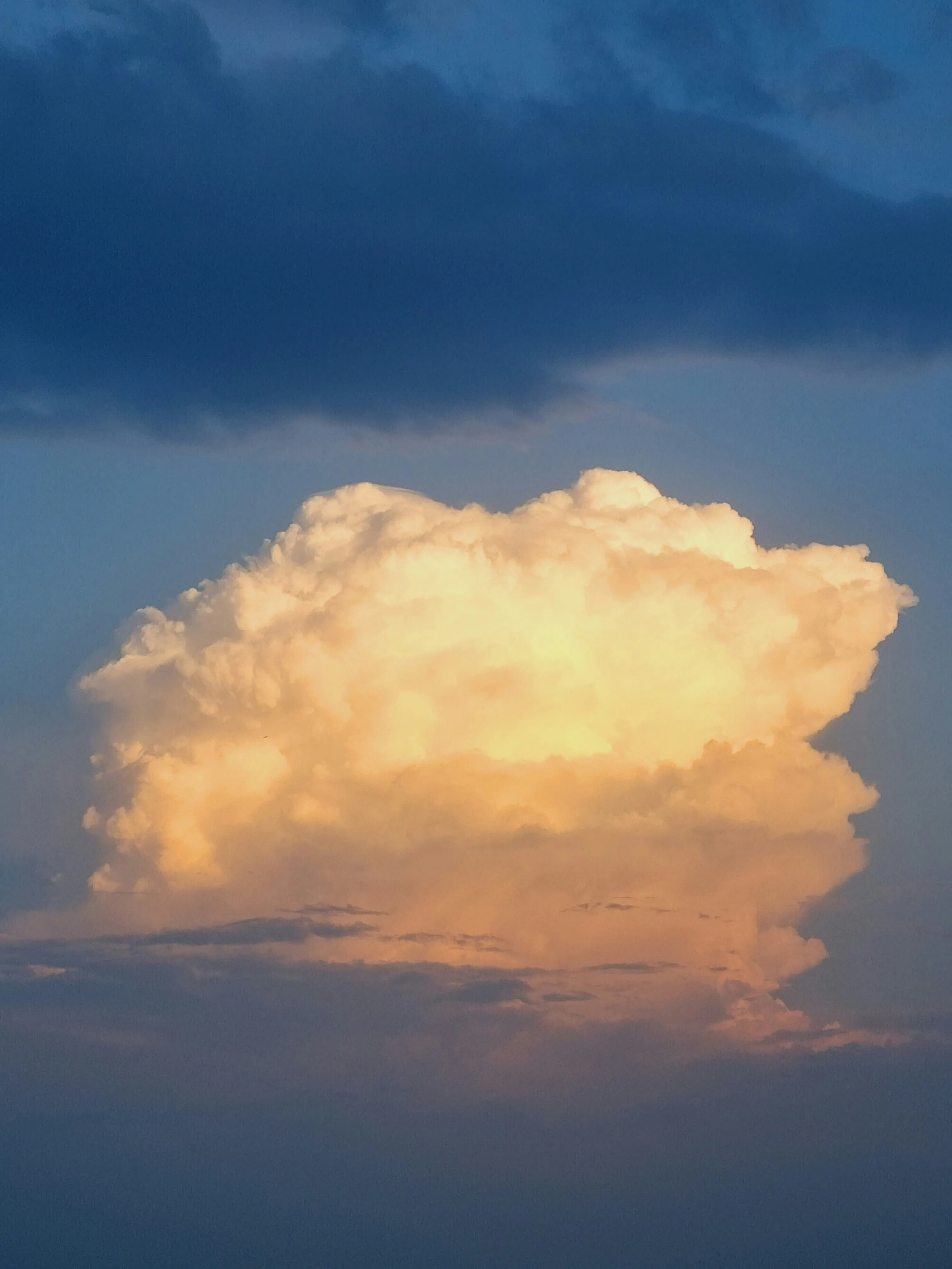 Bright Orange Thundercloud Over Calm Dark Blue Ocean