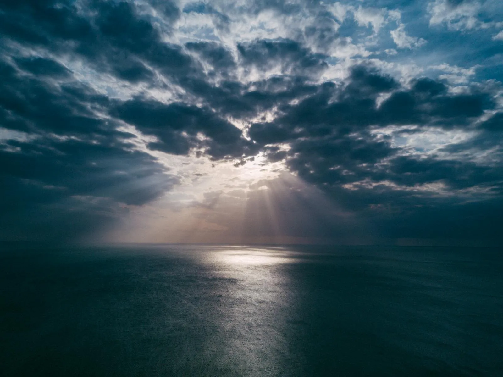 Bright Sunlight Piercing Through Dense Cloud Cover Image