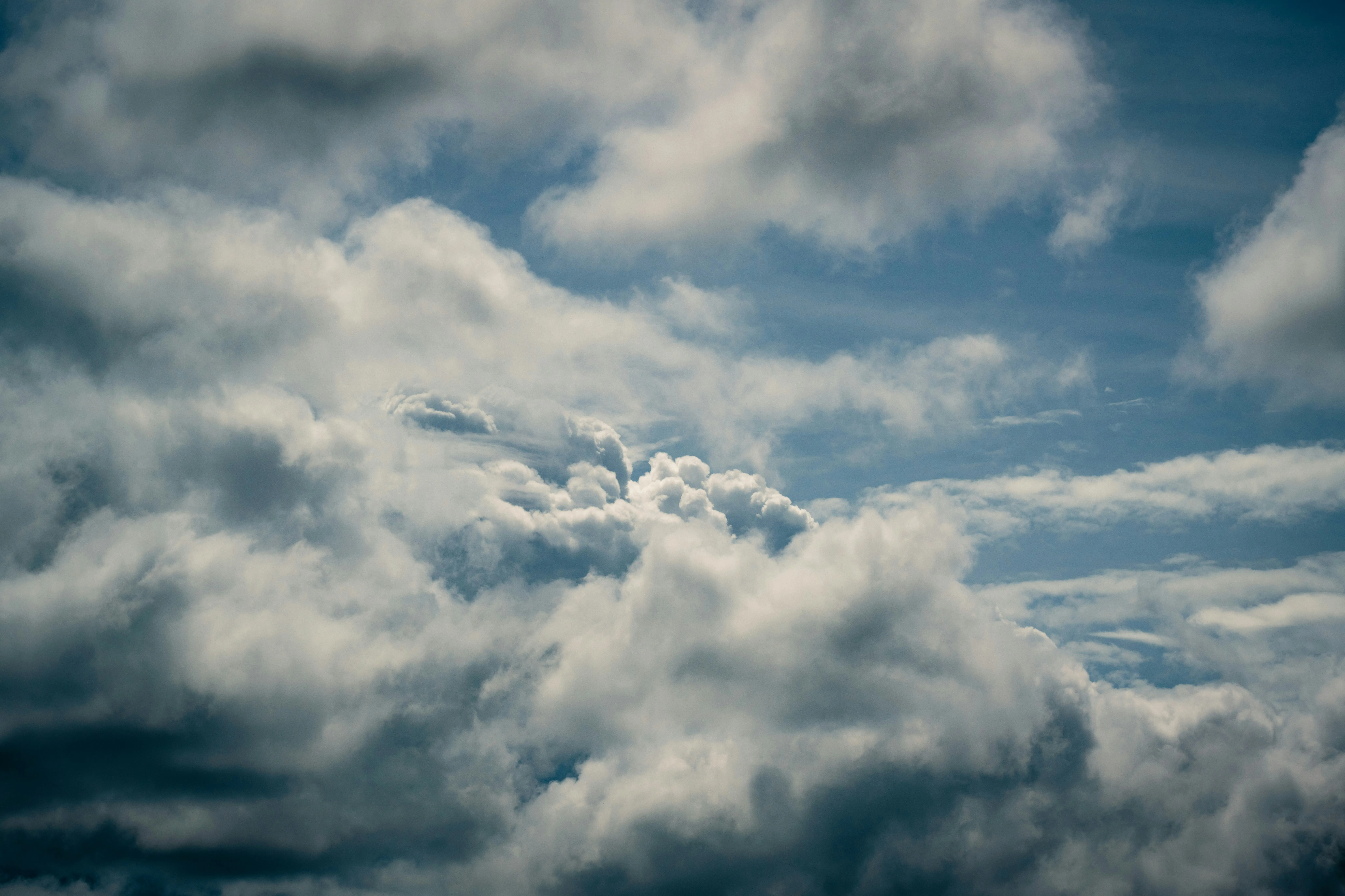 Bright Sunlight Piercing Through Puffy White Sky Clouds