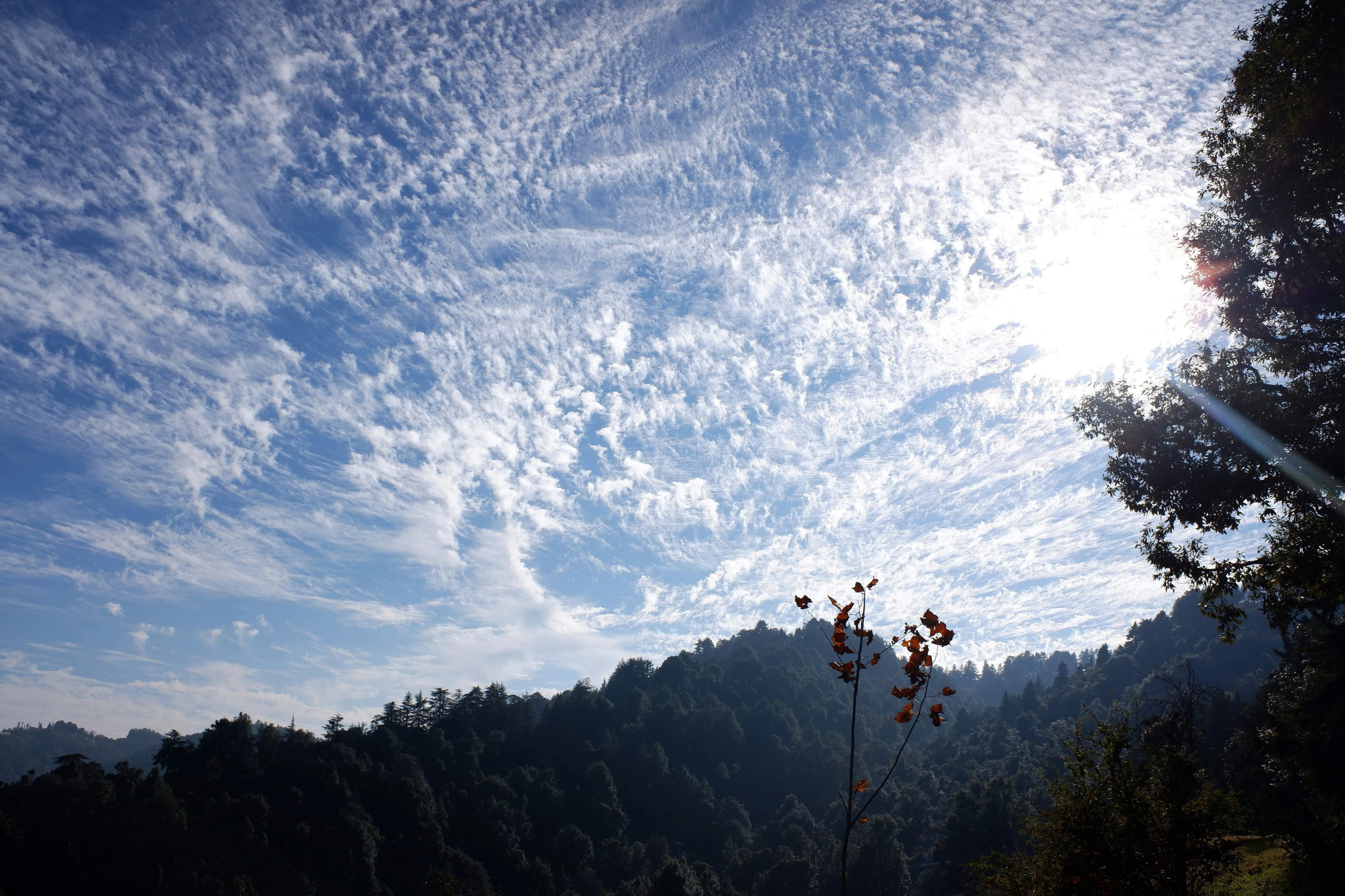 Bright Sunlight Shining Through Scattered Clouds Wallpaper