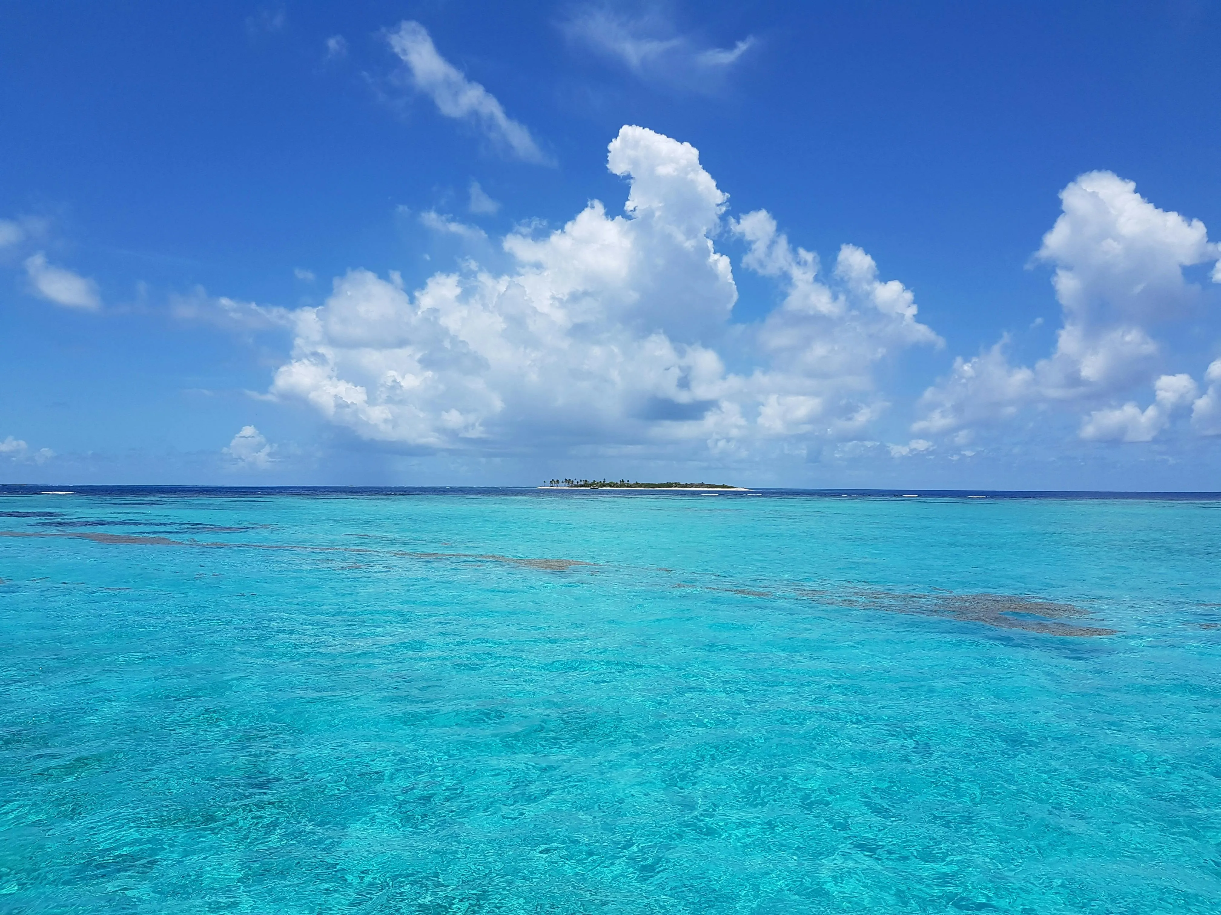 Bright Tropical Sky Over Crystal Blue Ocean Water Image