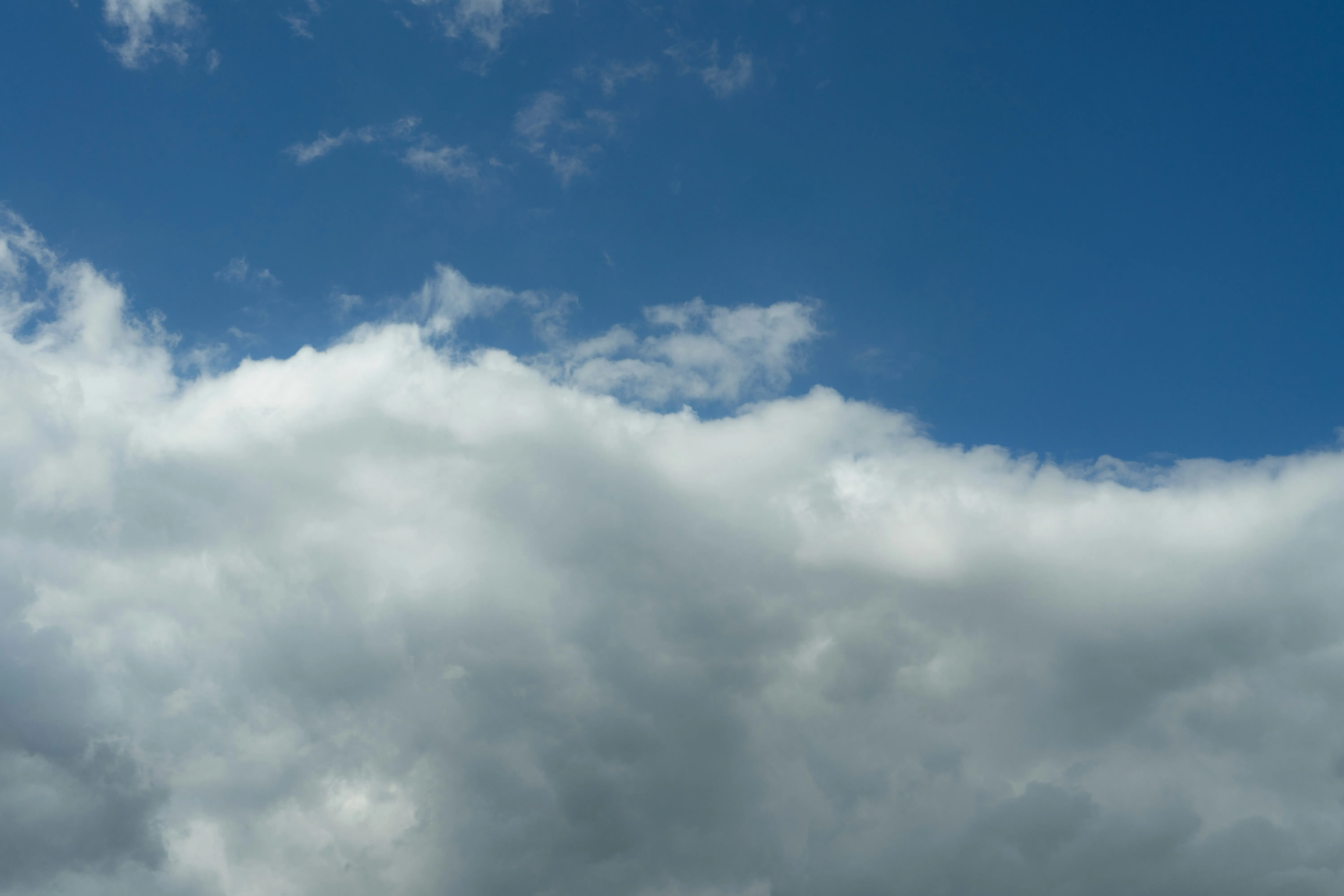 Bright White Clouds Against a Deep Blue Sky on a Sunny Day