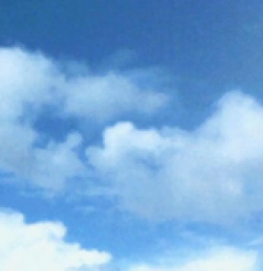 Bright White Fluffy Clouds Scattered in a Blue Sky Image