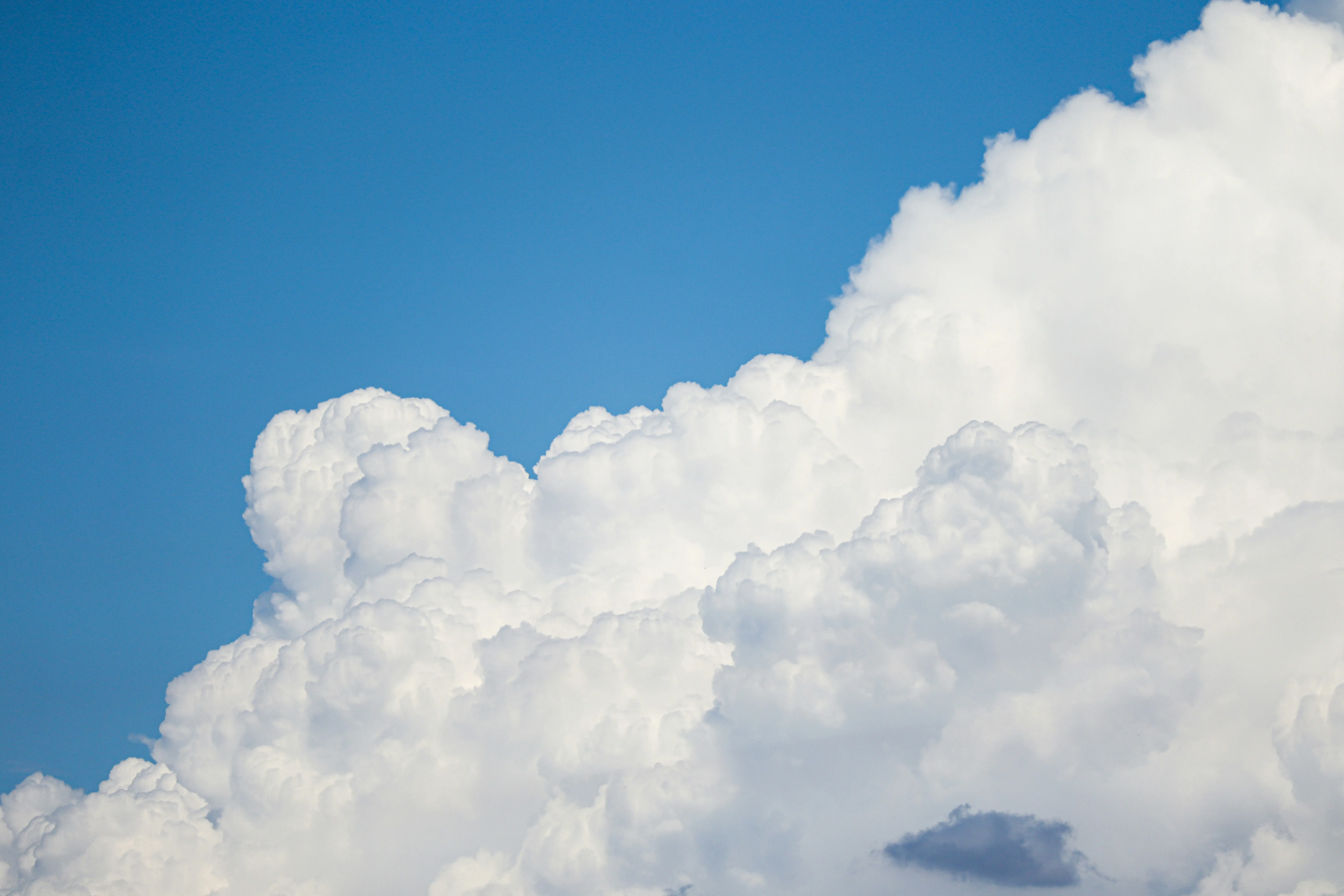 Bright White Puffy Clouds in a Vibrant Blue Sky Wallpaper