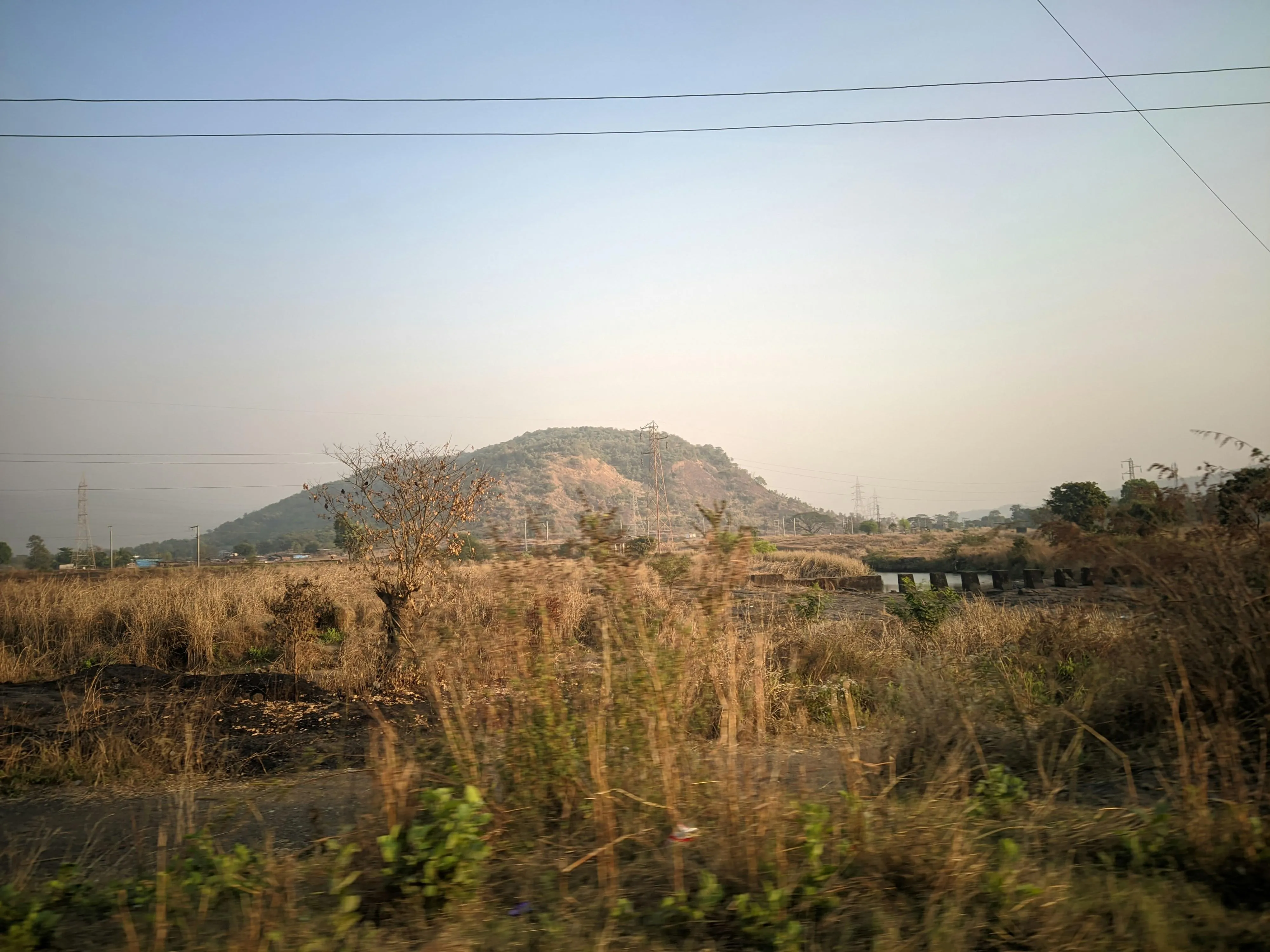 Brown Hills and Fields under a Light Cloudy Sky image