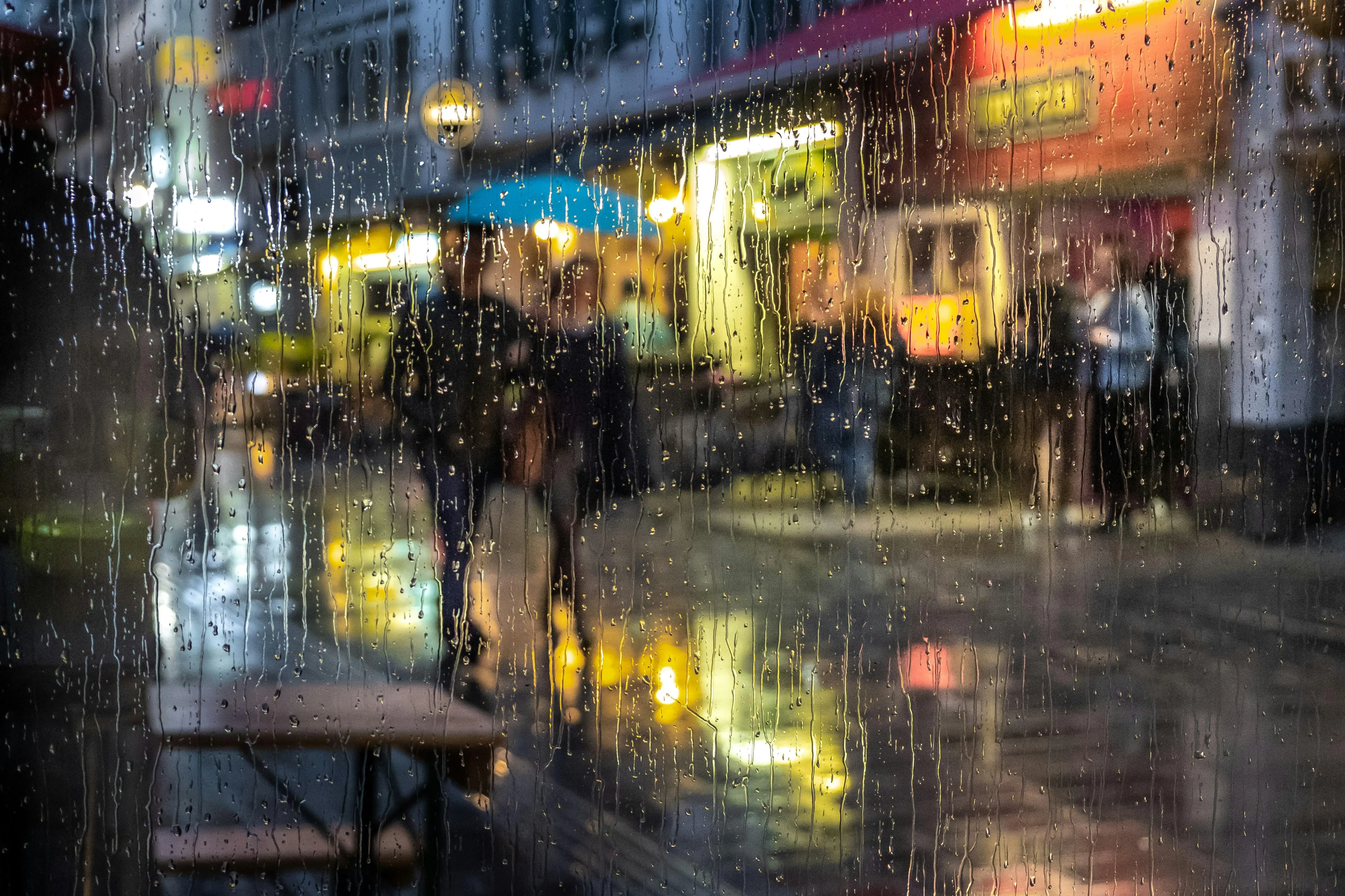 Busy City Street Illuminated By Lights and Rain Image