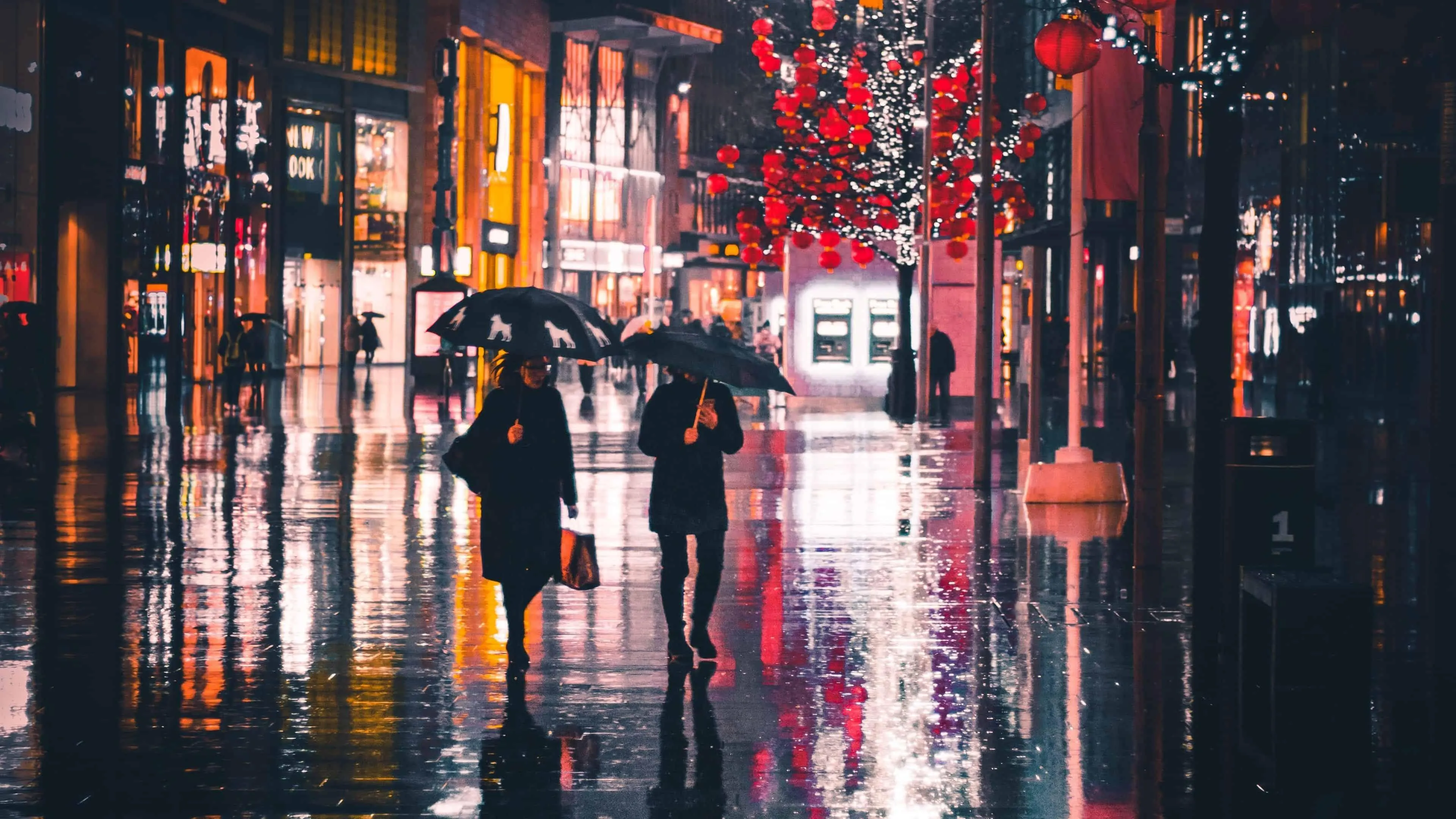 Busy Urban Street Scene with Wet Pavement and Colorful Lights