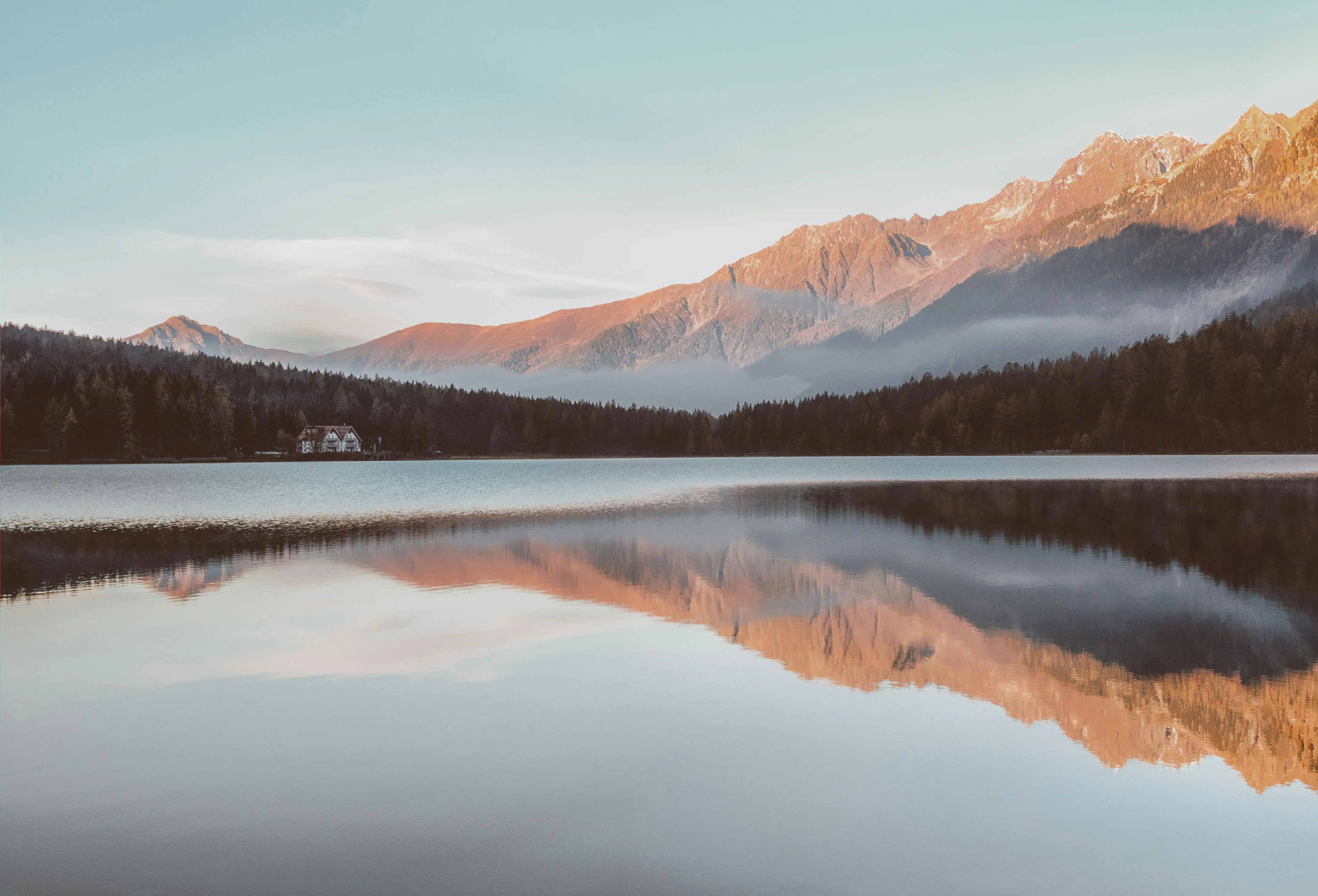 Calm Lake Reflects Clouds and Distant Mountains Wallpaper