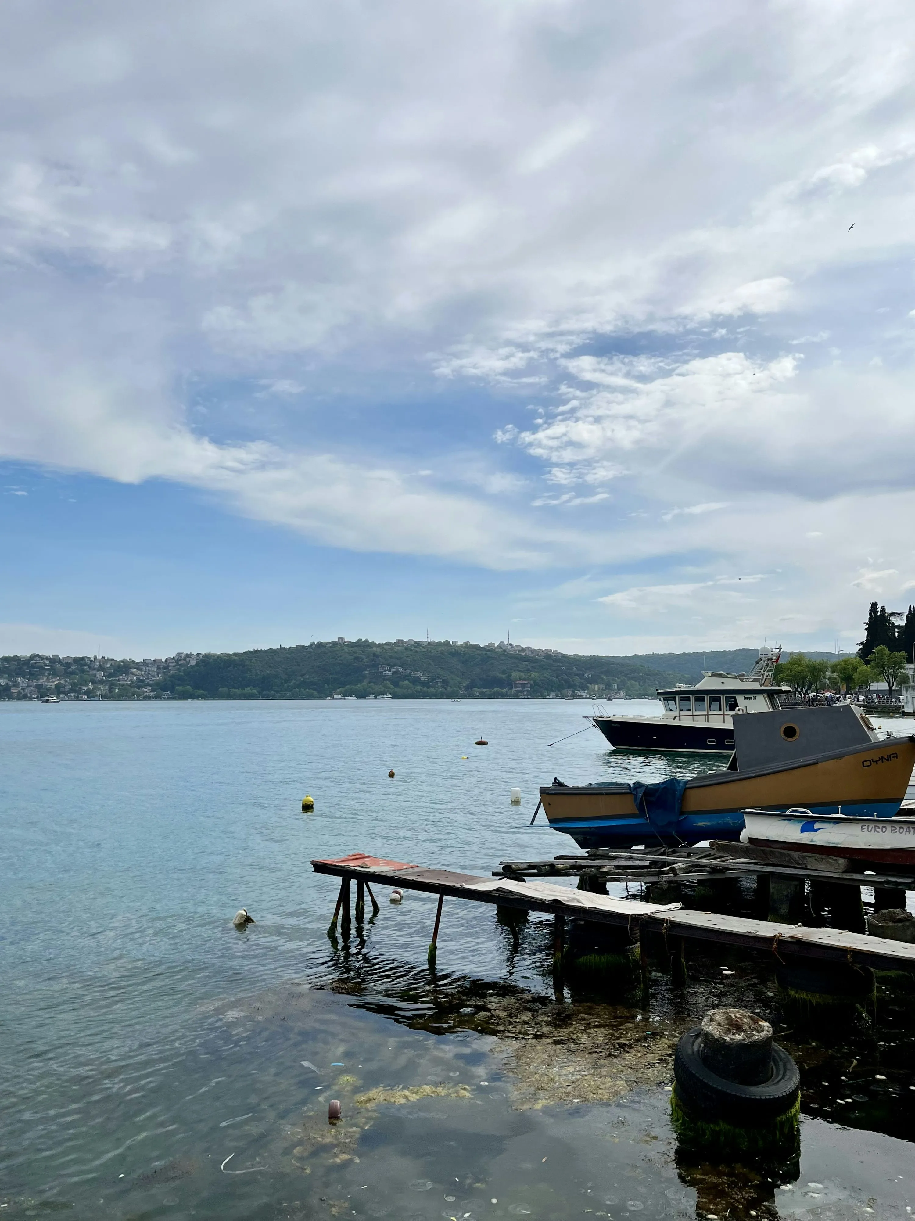 Calm Lake Scene with Boats and Peaceful Clouds Wallpaper