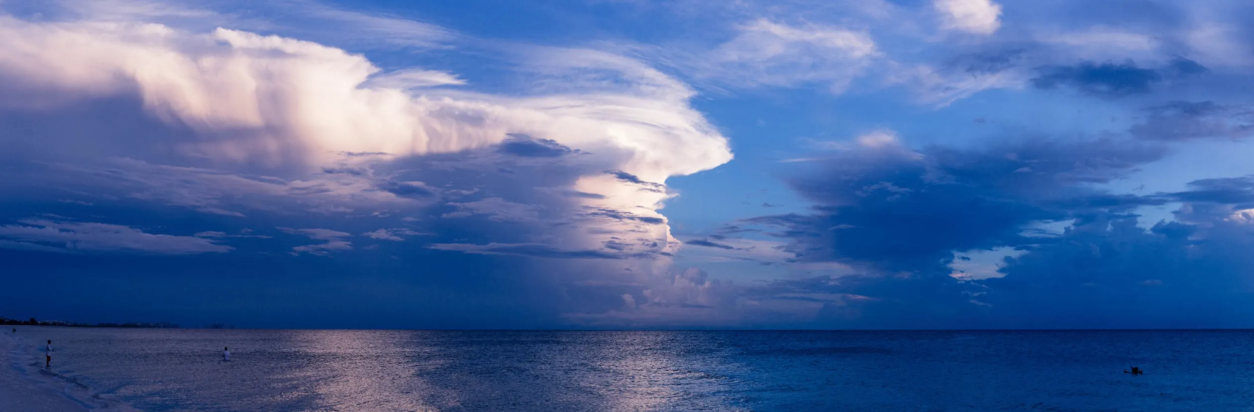 Calm Ocean Horizon with Dramatic Cloud Formation Photo