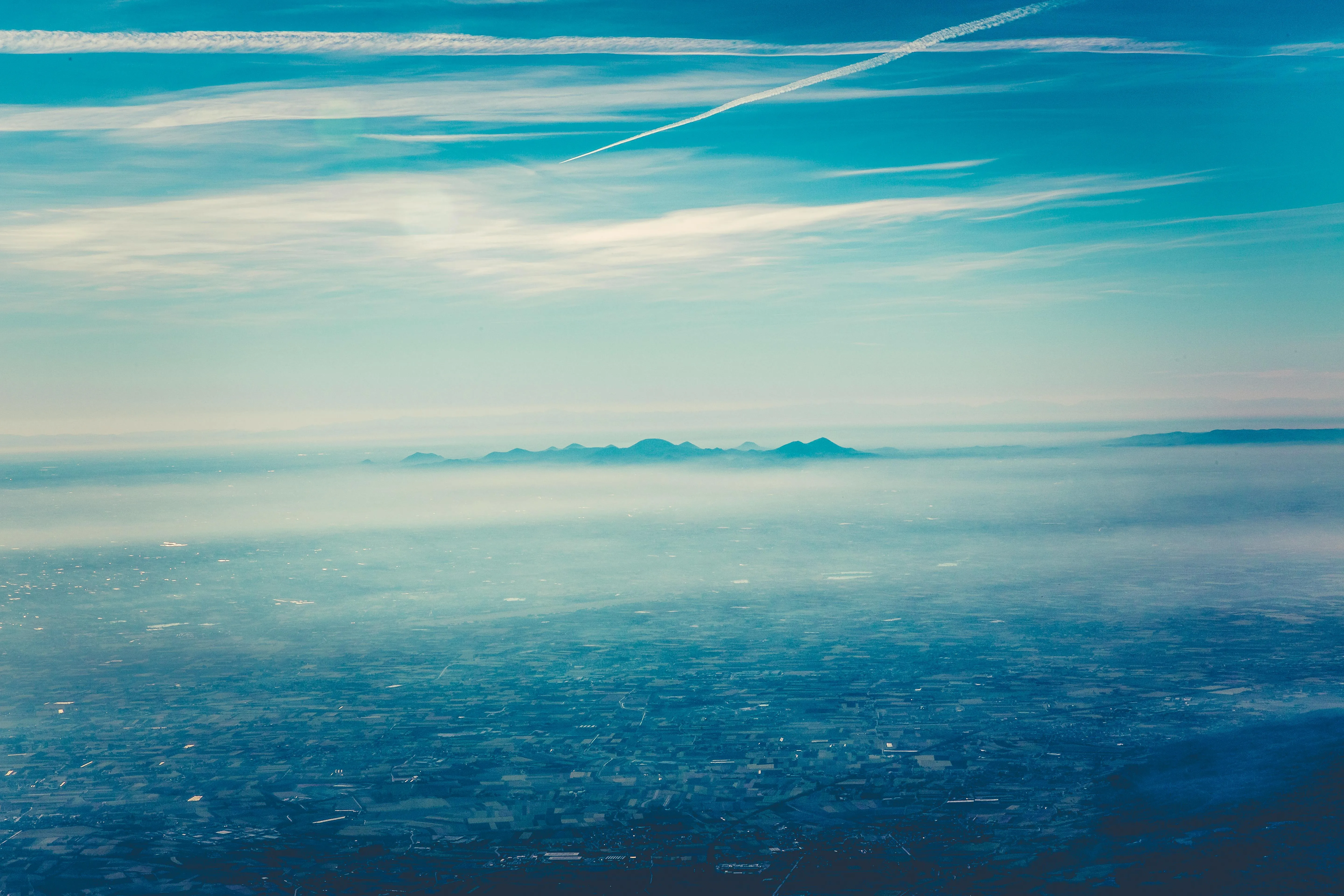 Calm Ocean with Clear Sky and Clouds in the Distance