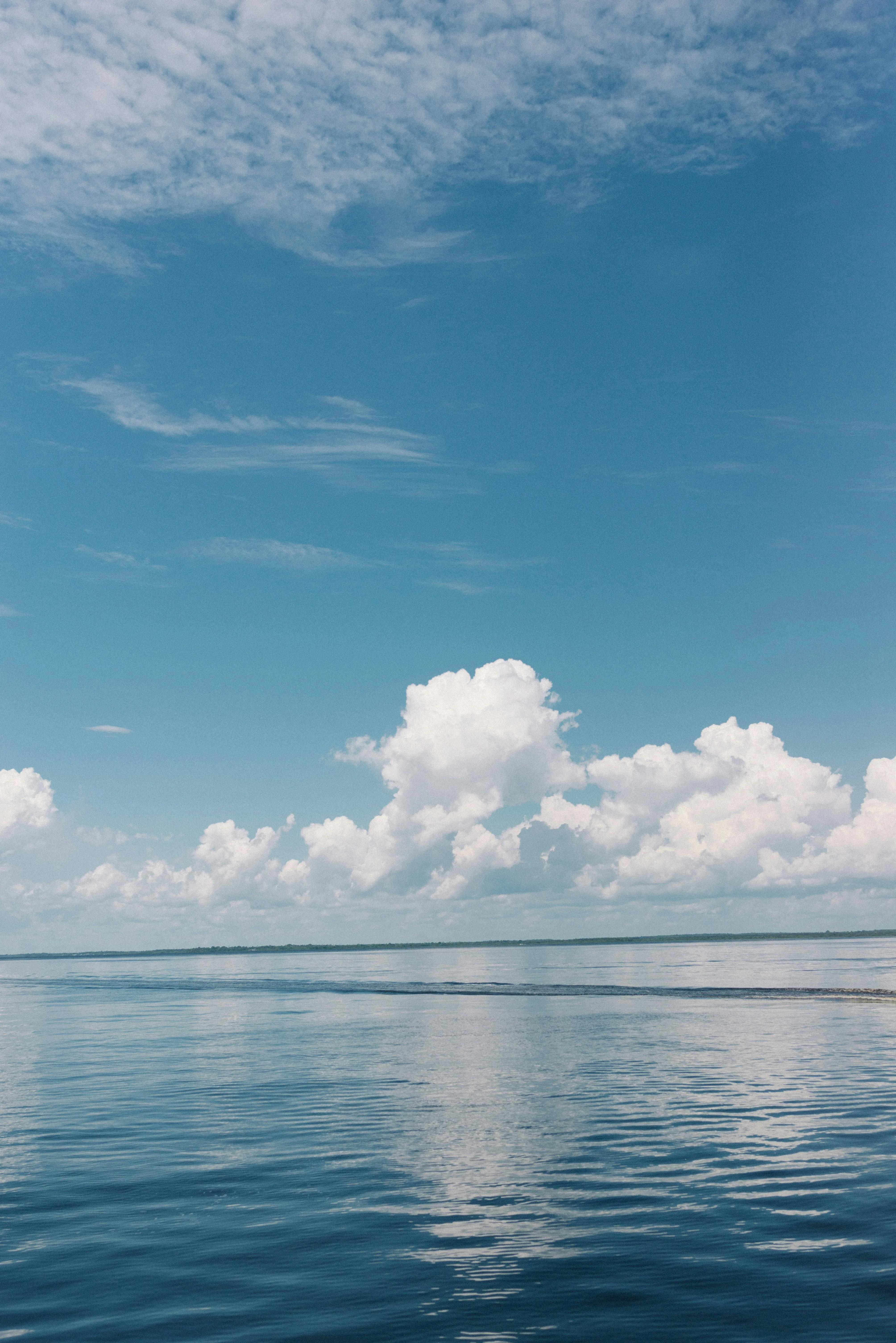 Calm Sea Reflecting Clouds Under Blue Sky Horizon Wallpaper