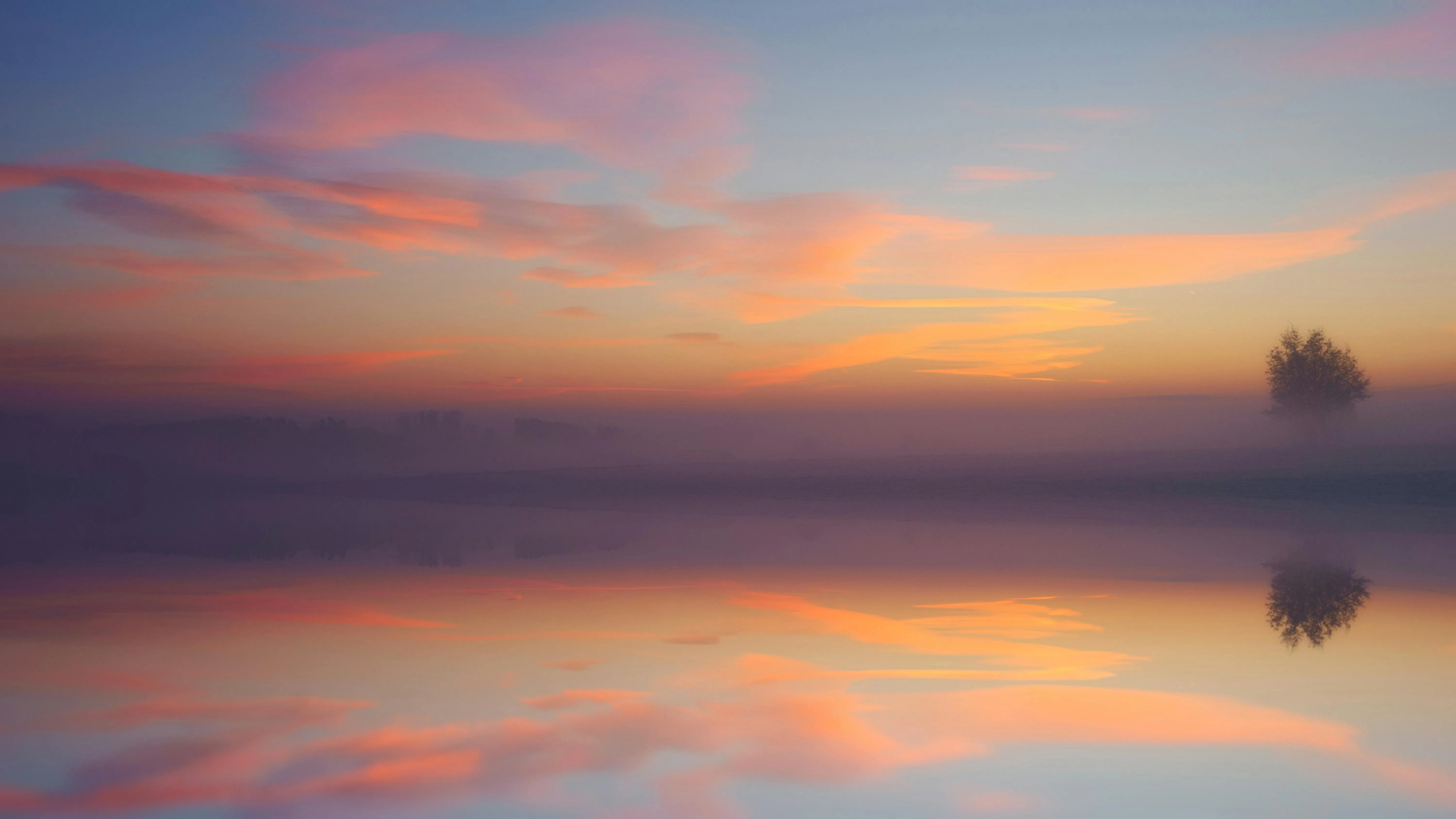 Calm Sunset Over Water with Blended Pink Clouds Image