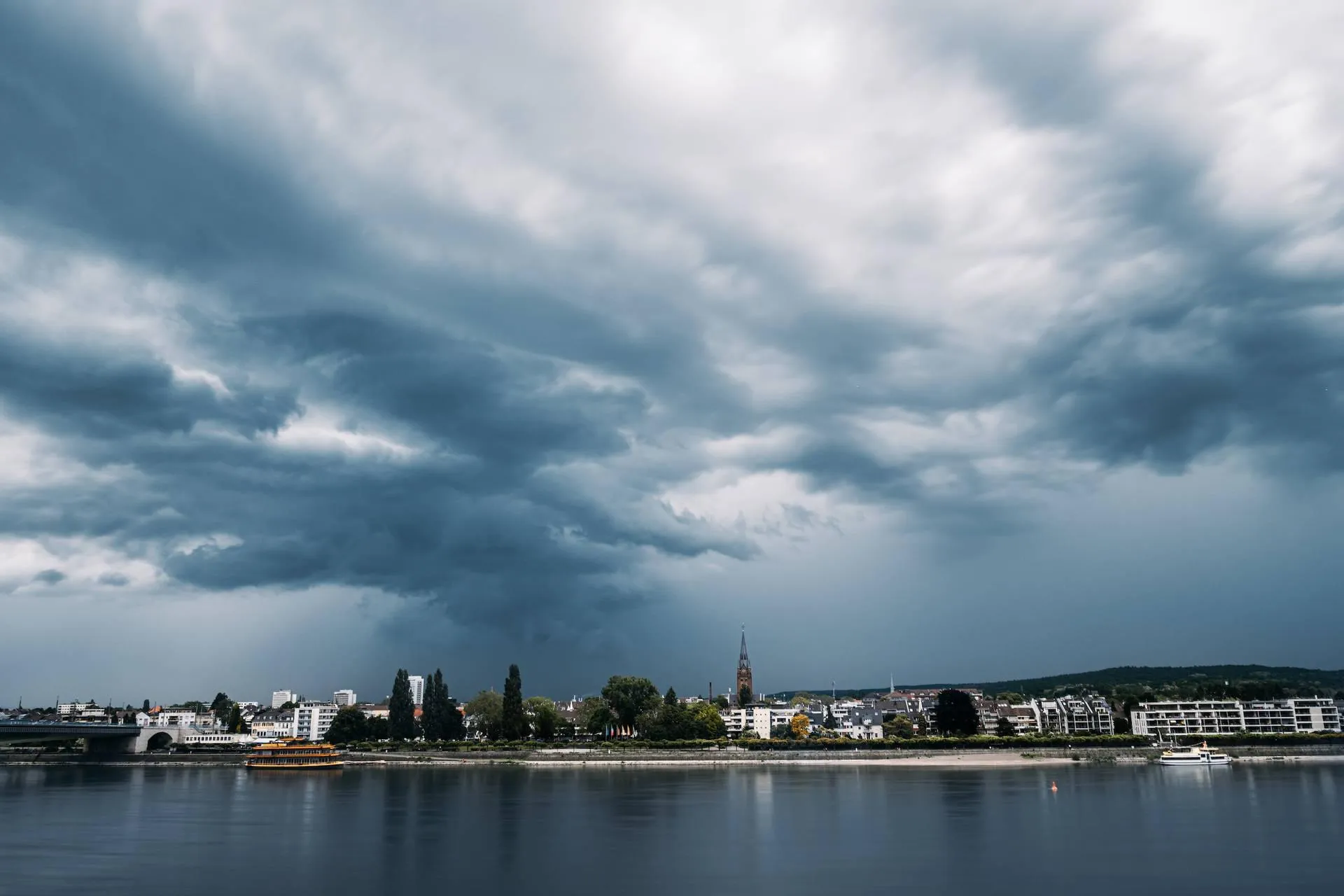 Calm Waterfront with Clouds and Buildings in the Distance