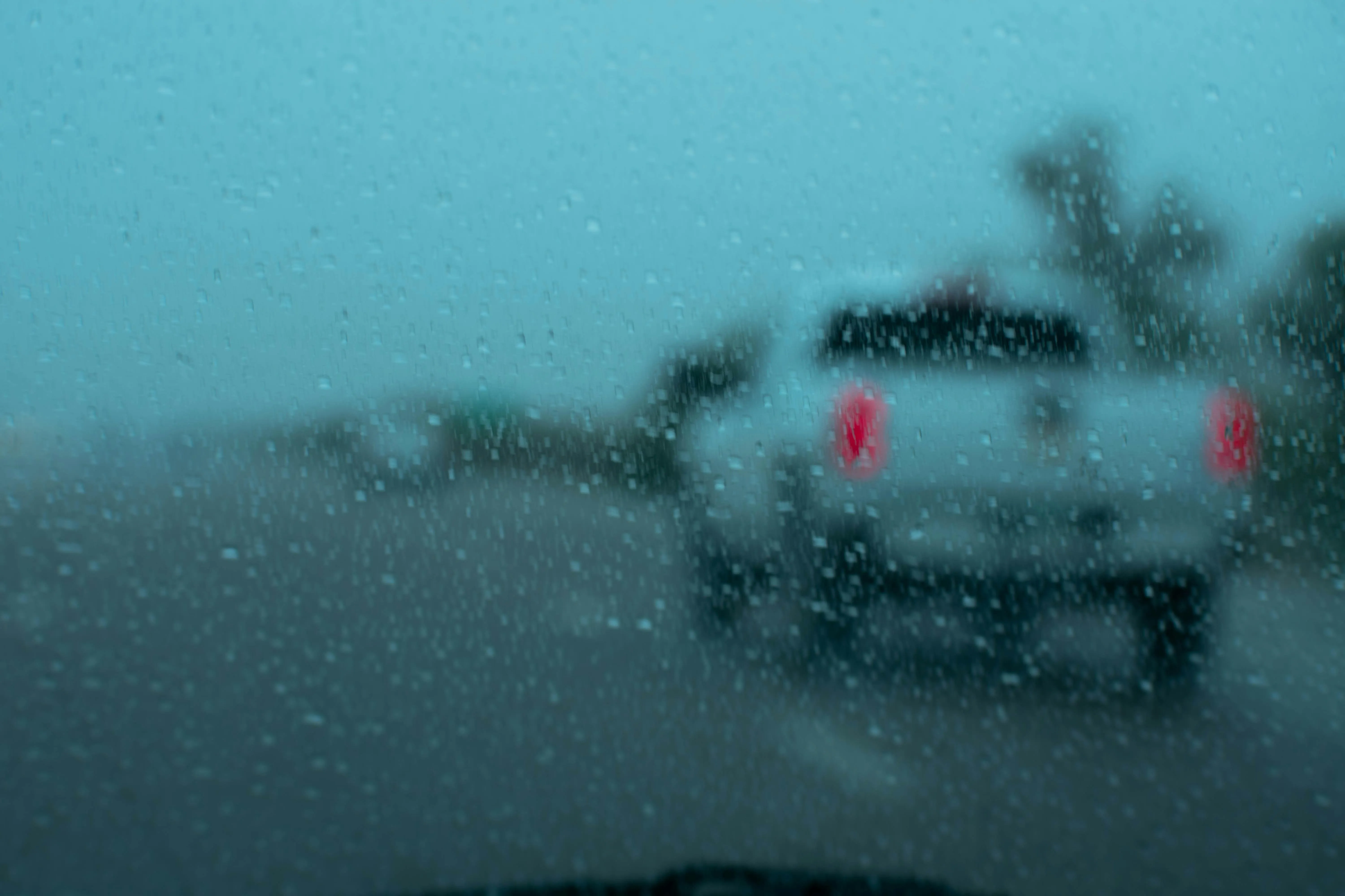Car Driving Through Heavy Rain on Street Wallpaper