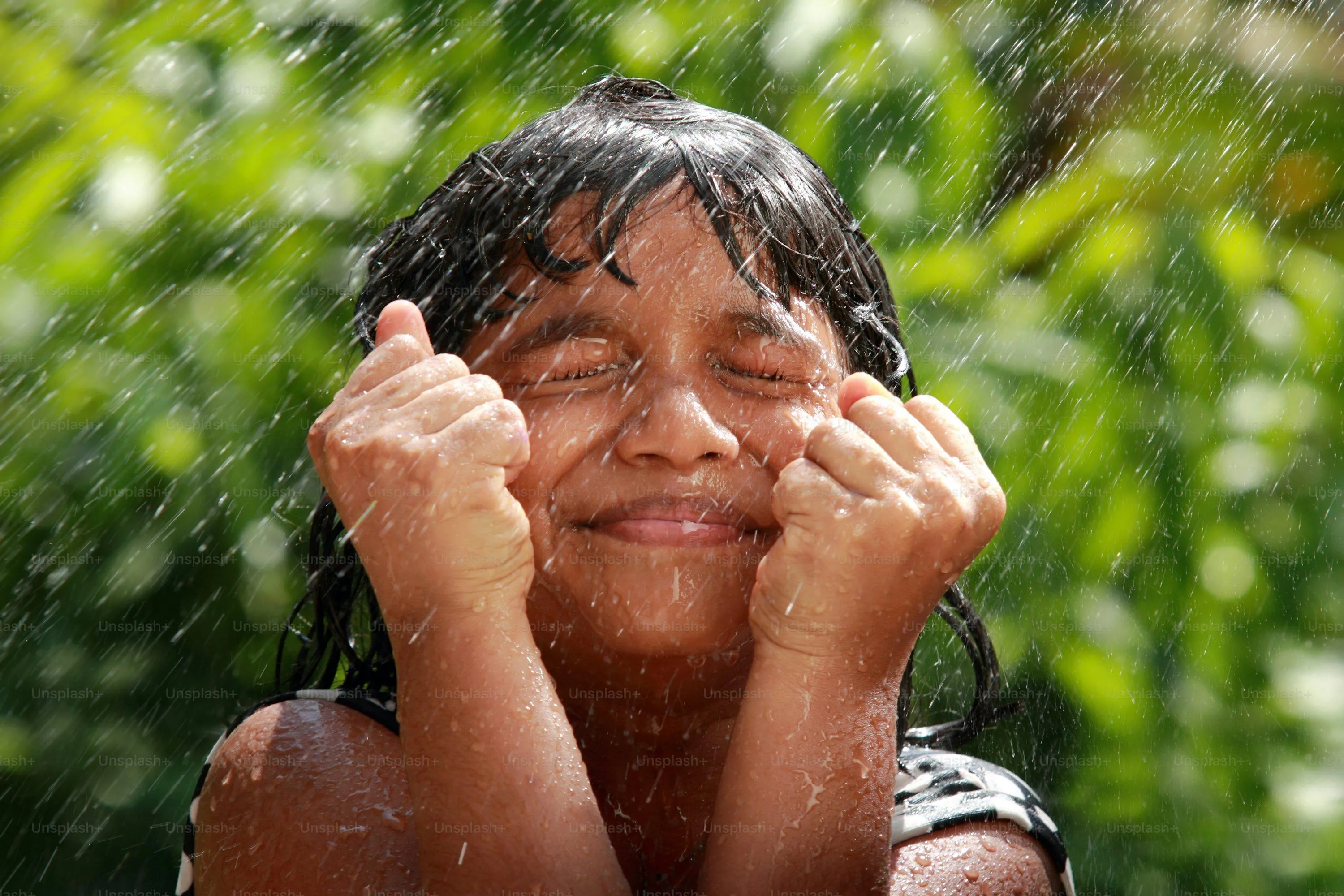 Child Enjoying Rain with Playful Face and Closed Eyes