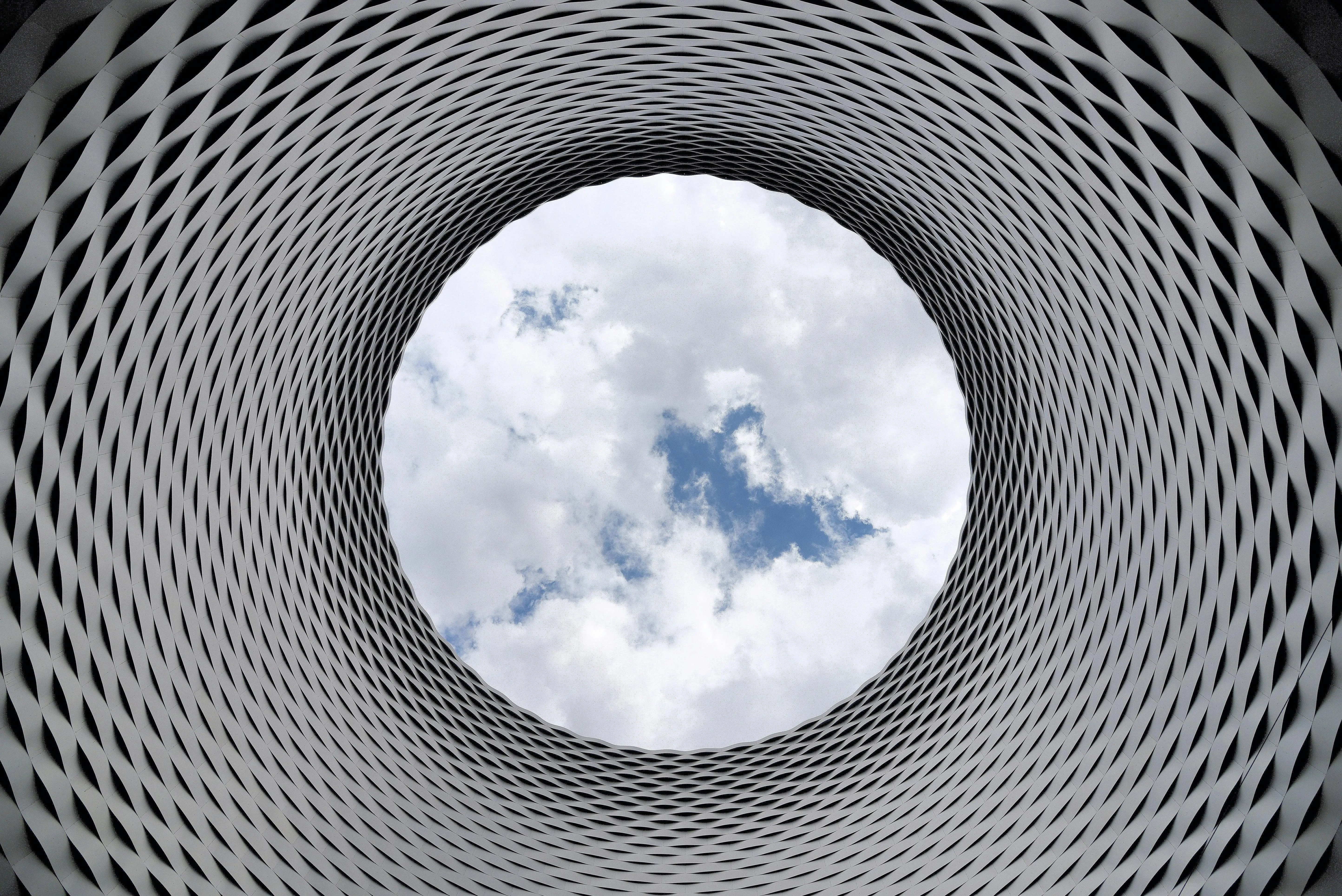 Circular Tunnel Pattern Showing Sky Through Center Wallpaper