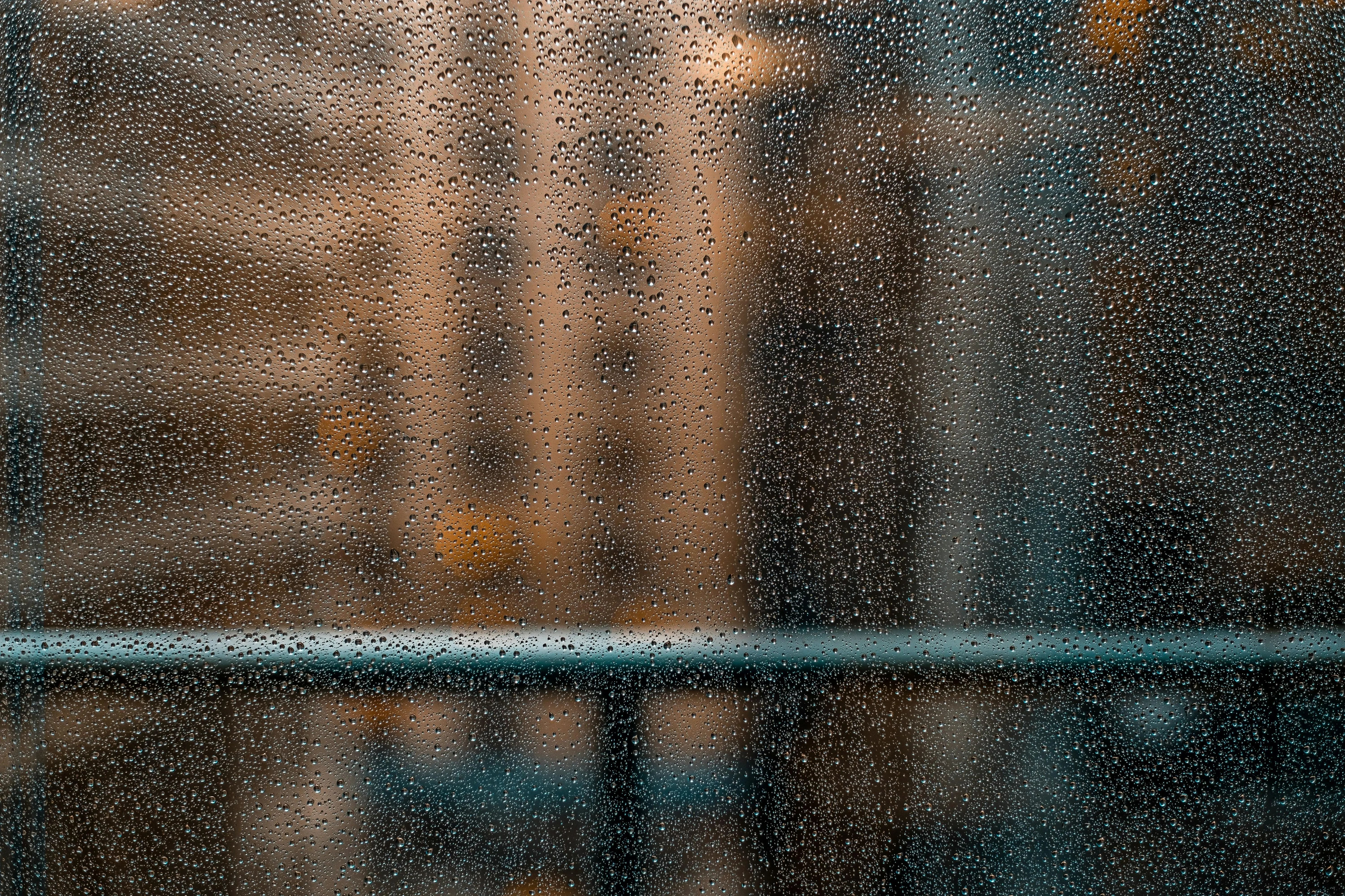 City Buildings Blurred By Rain Drops on Window Wallpaper