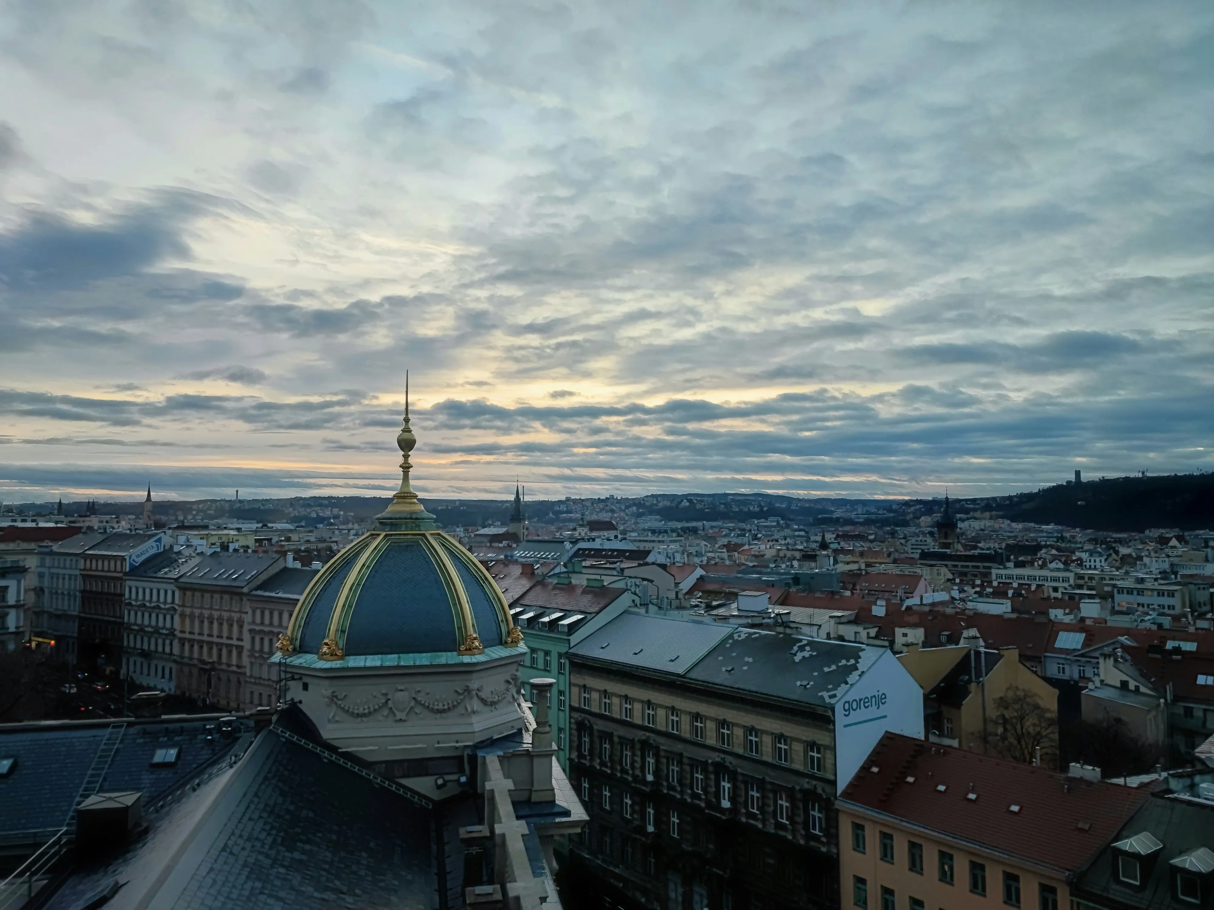 City Rooftop Under Dramatic Cloudy Evening Sky Wallpaper