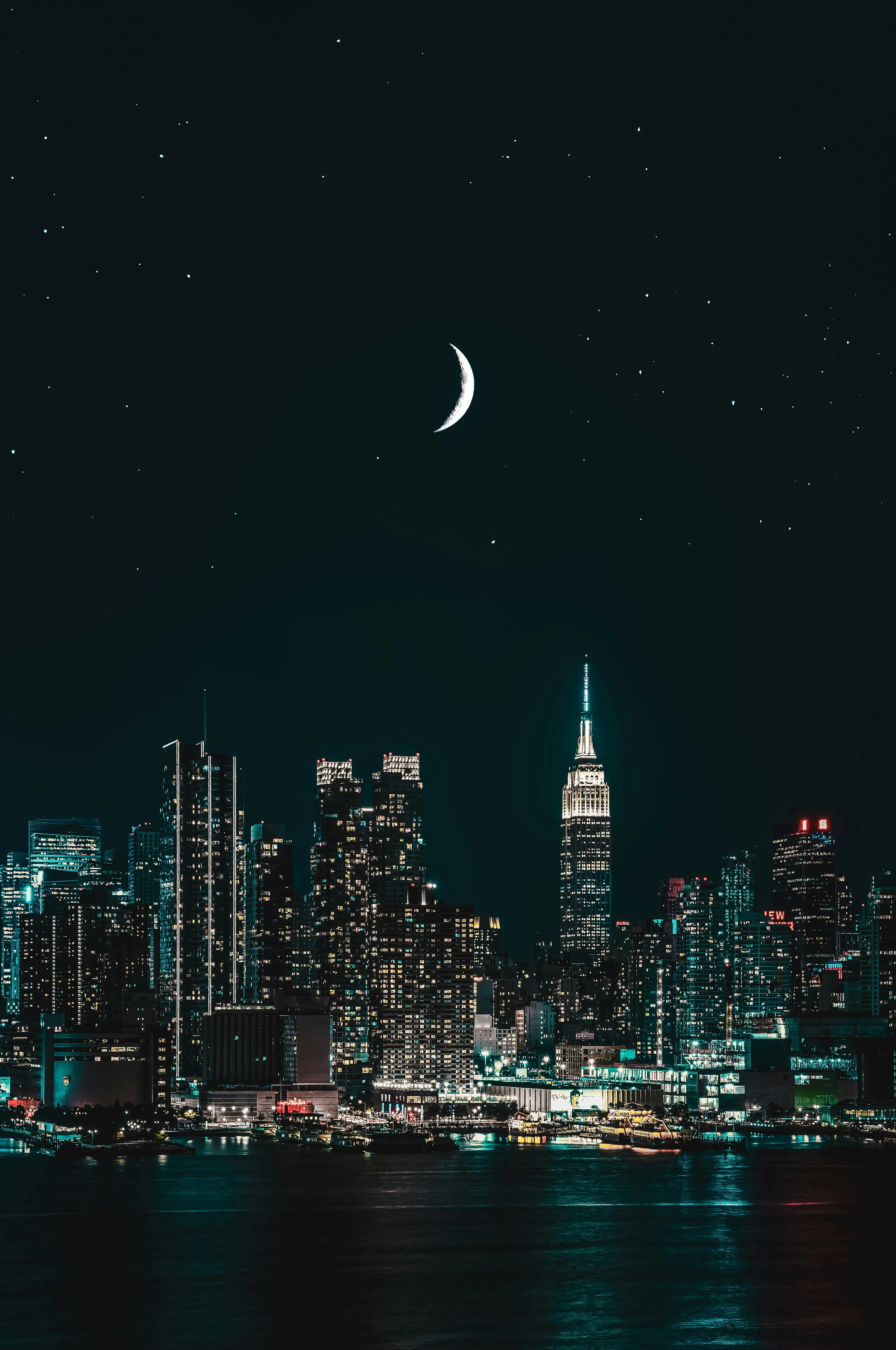City Skyline at Night with Crescent Moon and Dark Sky