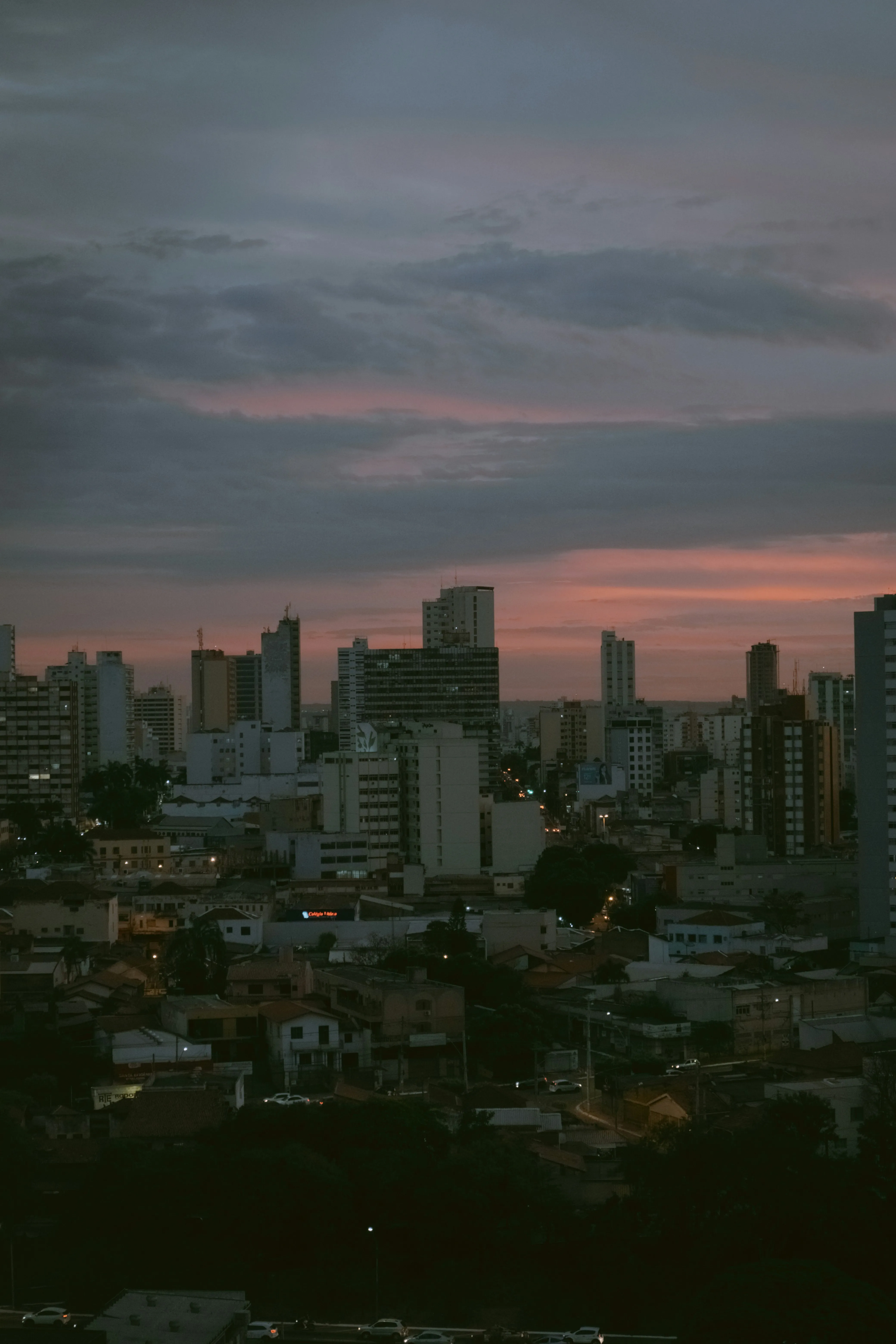 City Skyline at Sunset with Pink and Purple Clouds Above