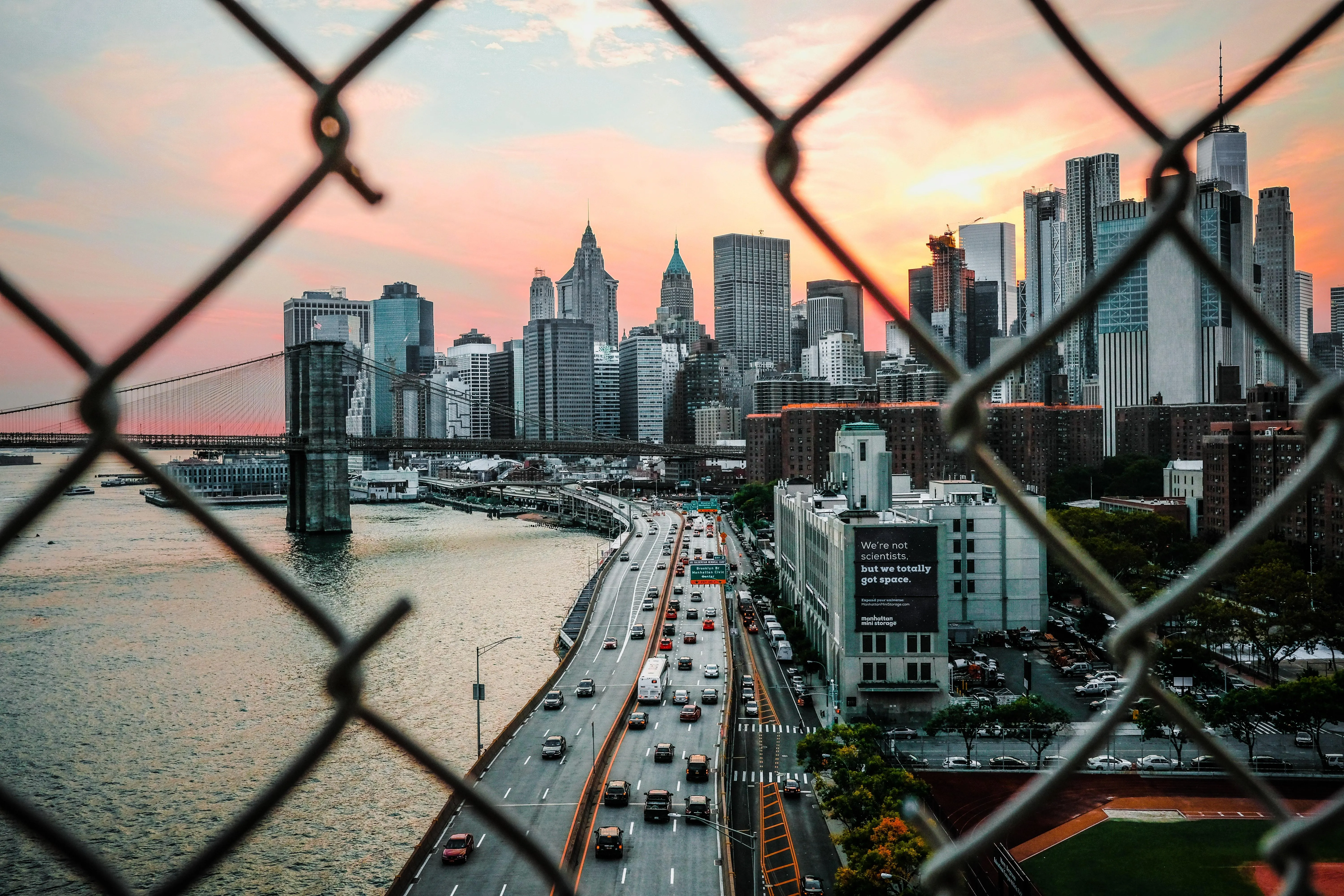 City Skyline Behind Wire Fence at Sunset free image