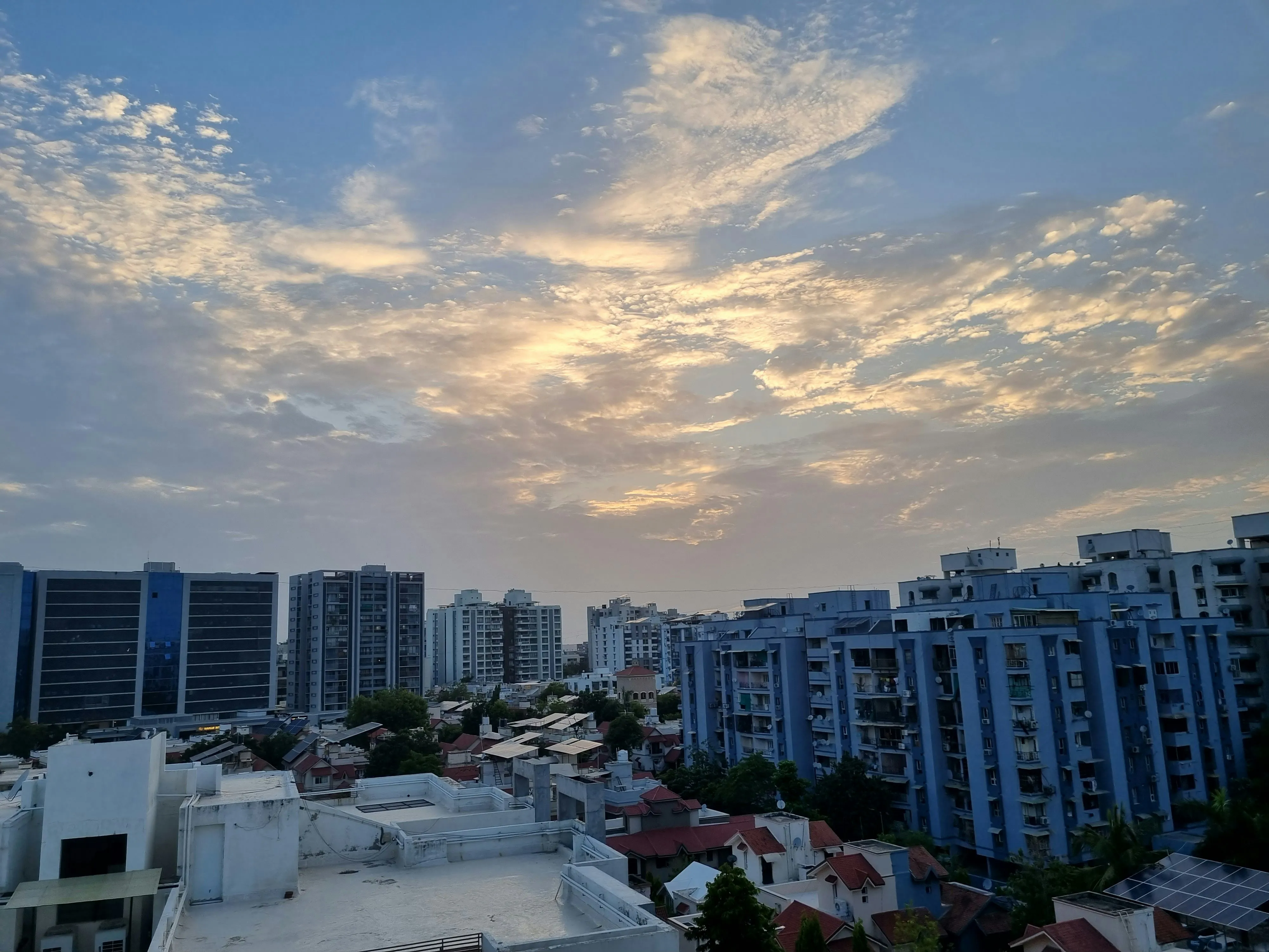 City Skyline Beneath a Dramatic Cloudy Sky at Dusk Image