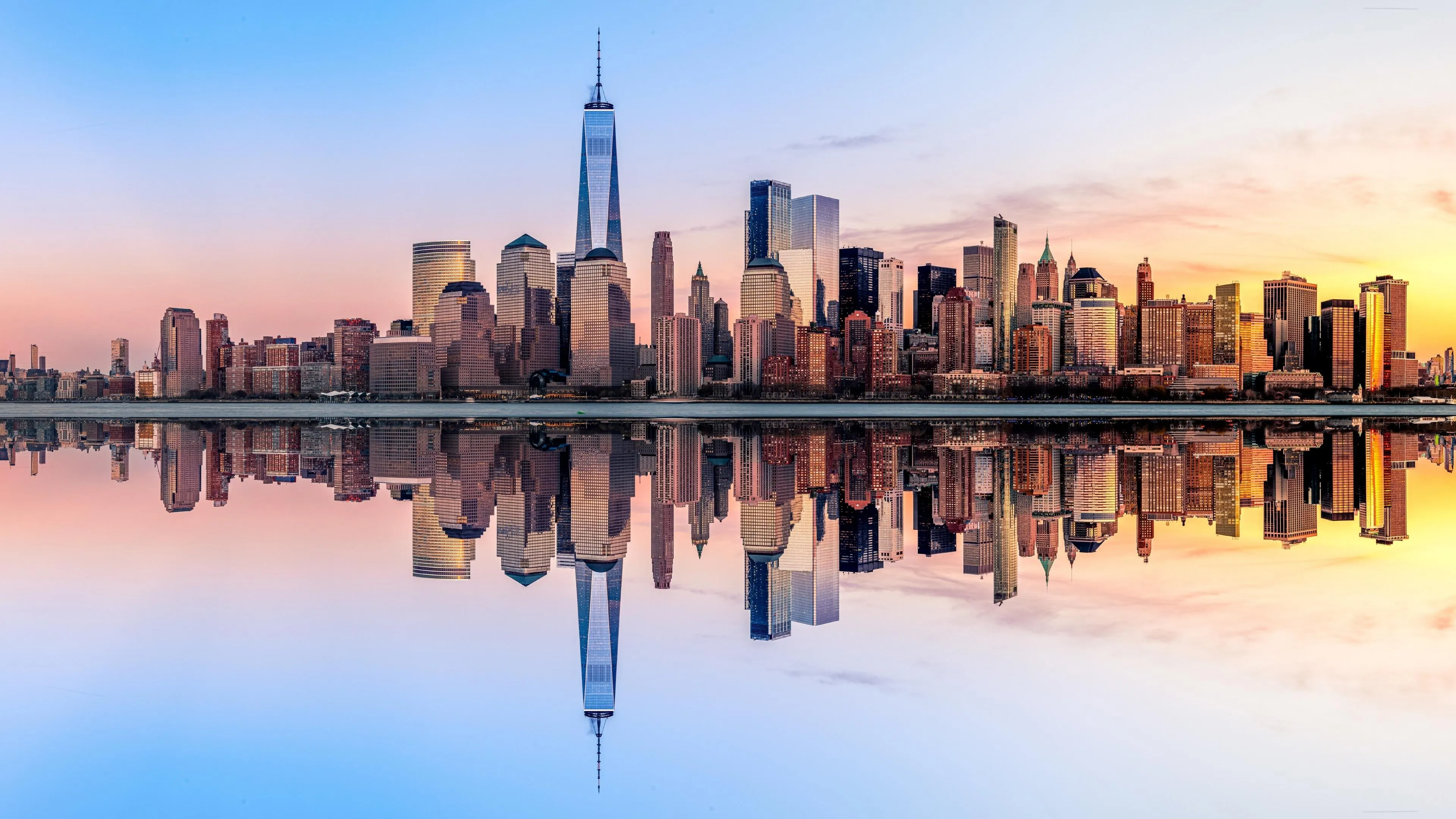 City Skyline Reflected on Still Water at Sunrise Wallpaper
