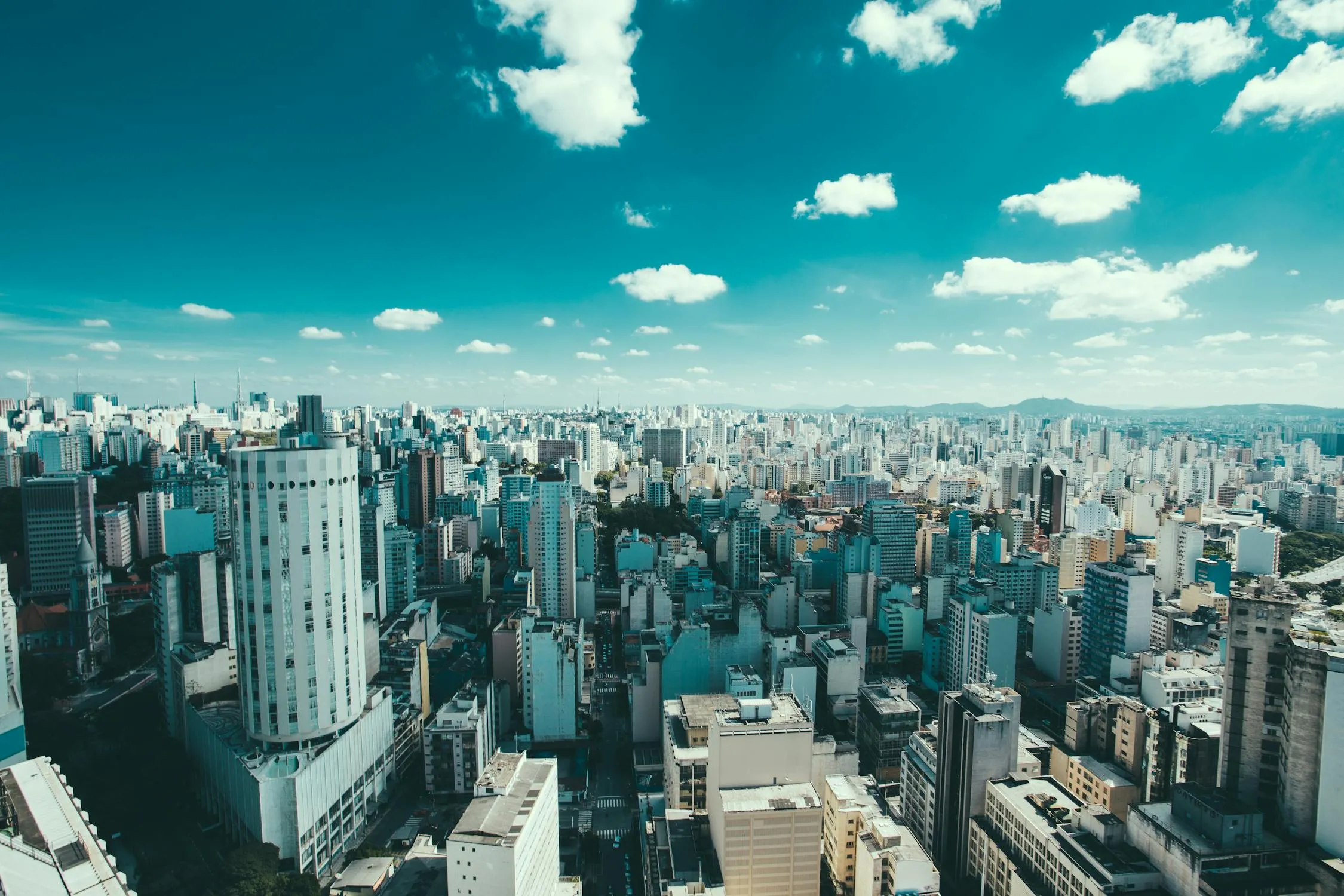 City Skyline with Clear Blue Sky and Clouds View Wallpaper