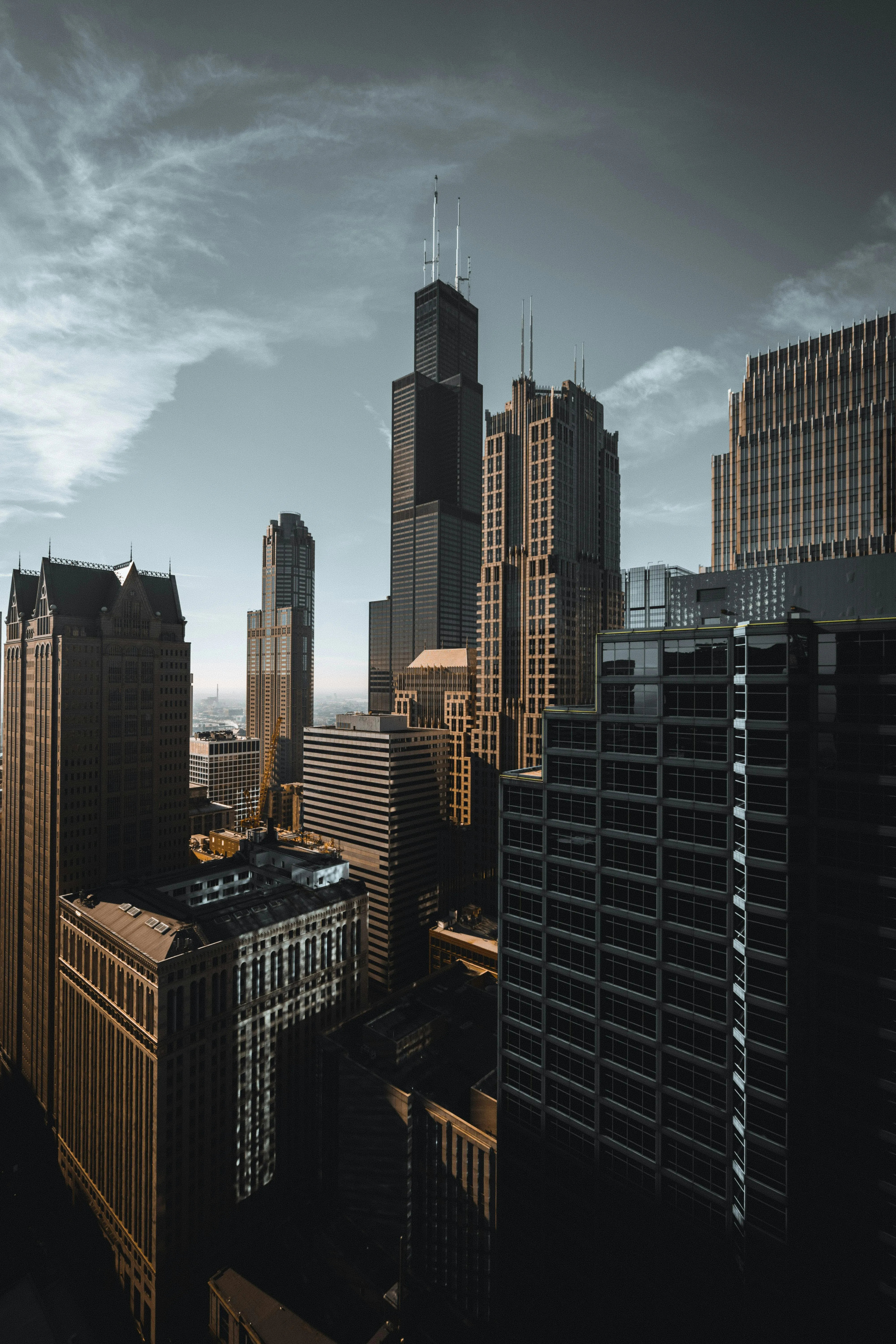 City Skyline with Tall Buildings Under a Bright Cloudy Sky