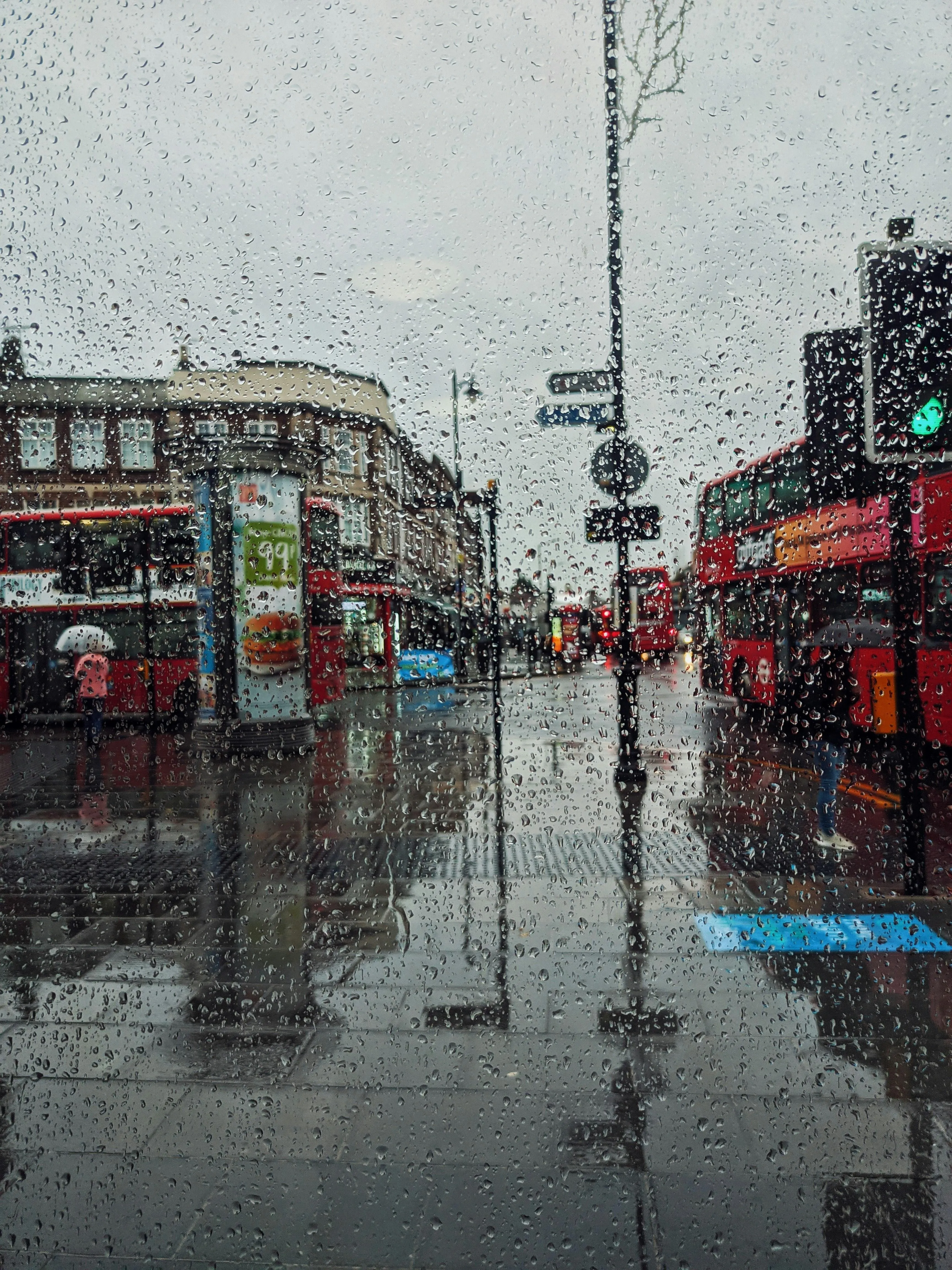 City Street with Traffic Lights and People in The Rain