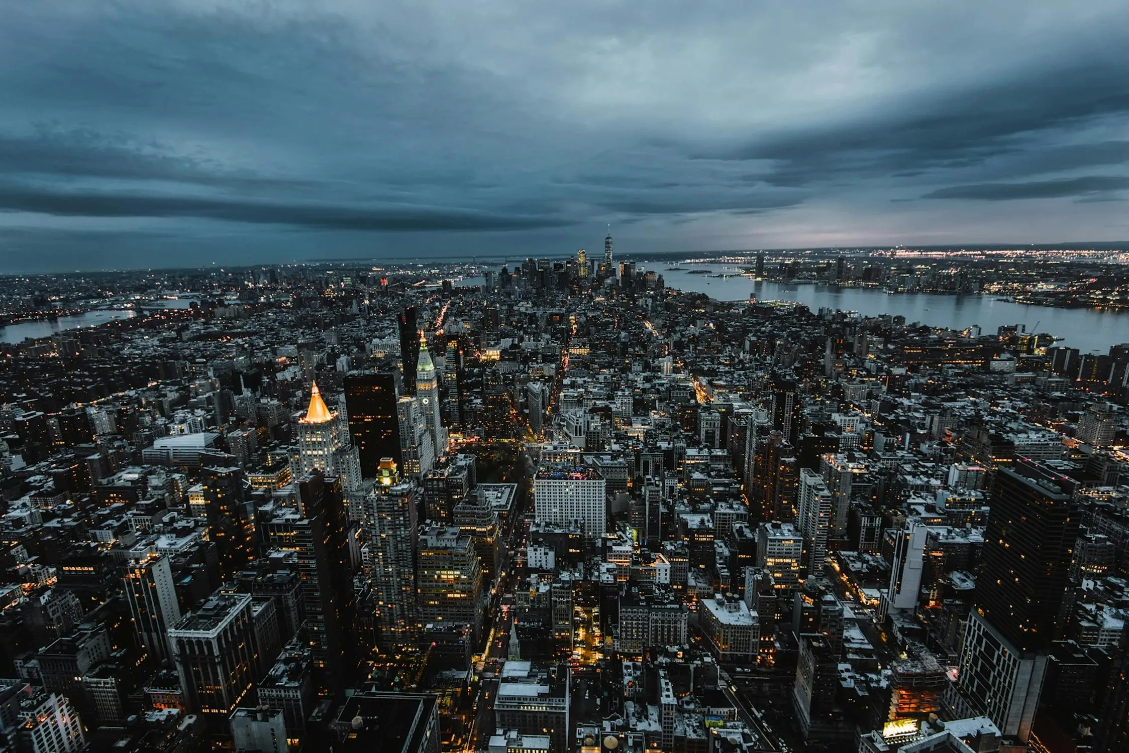 Cityscape Under a Moody Overcast Sky at Twilight Wallpaper