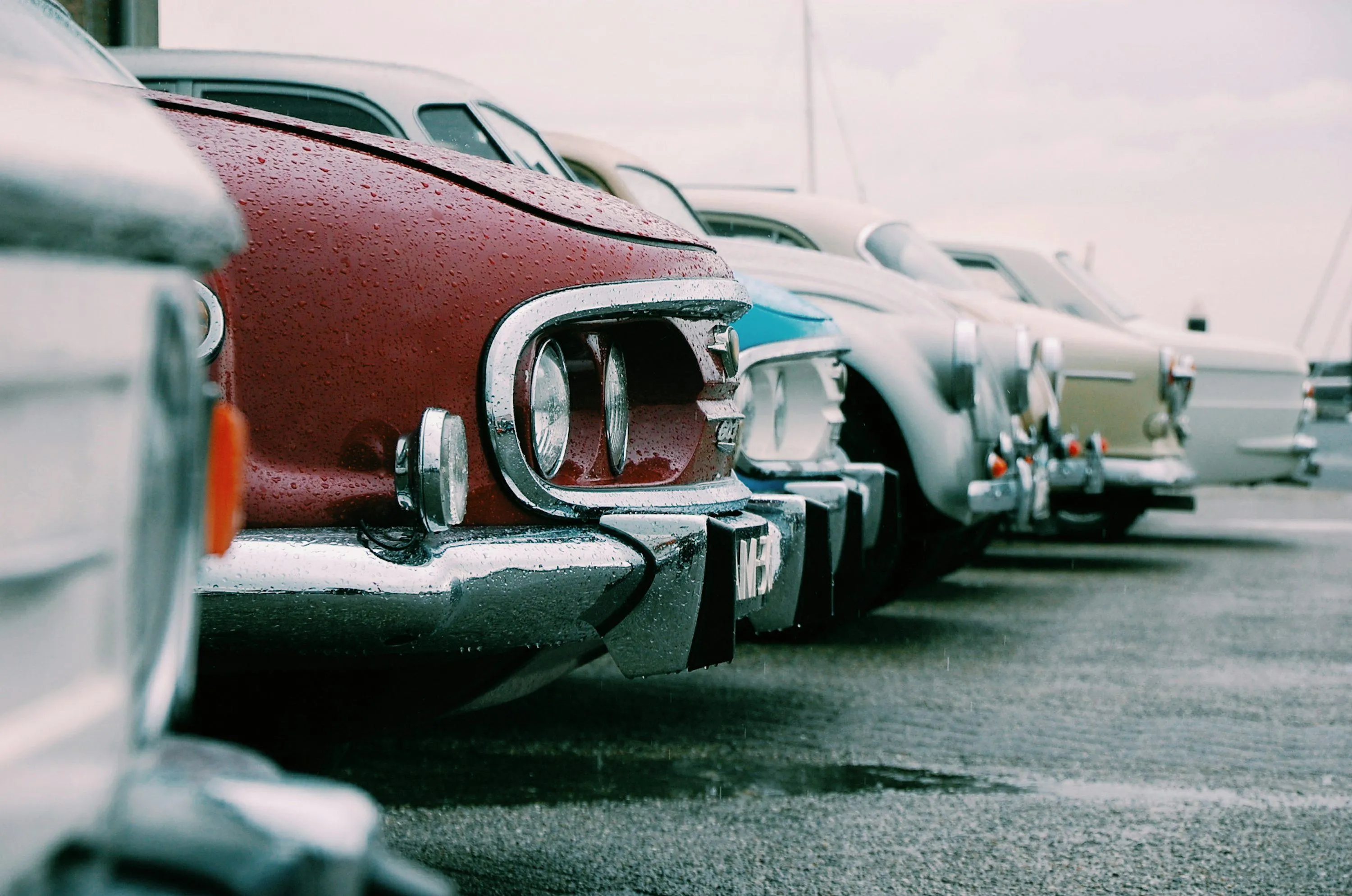 Classic Vintage Car Parked on Wet Road with Rain Droplets